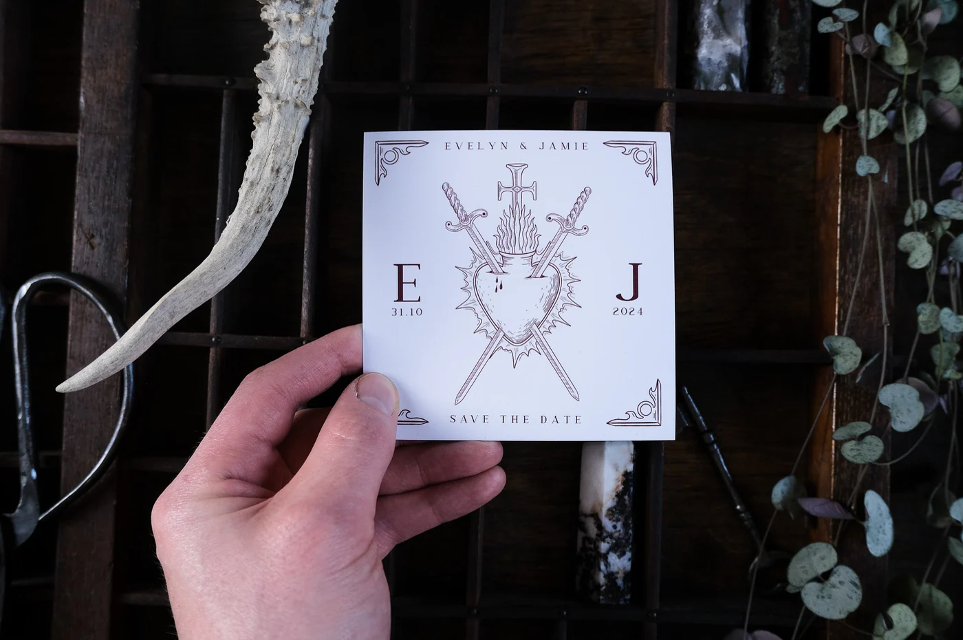 Hand holding wedding invite.