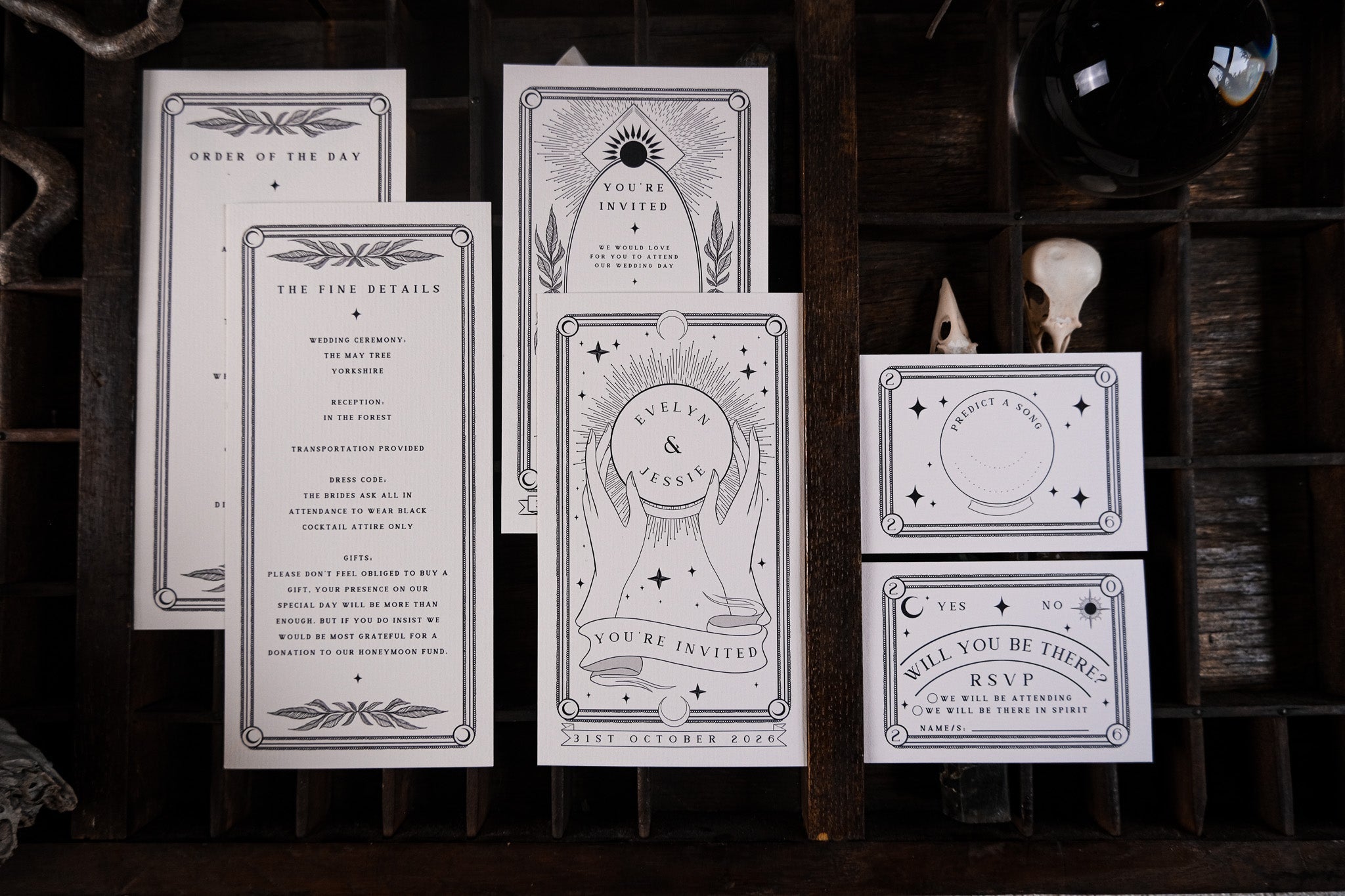 Luxury UK wedding stationery set featuring dramatic black and white celestial designs, with gothic stars, moons, and crystal balls.