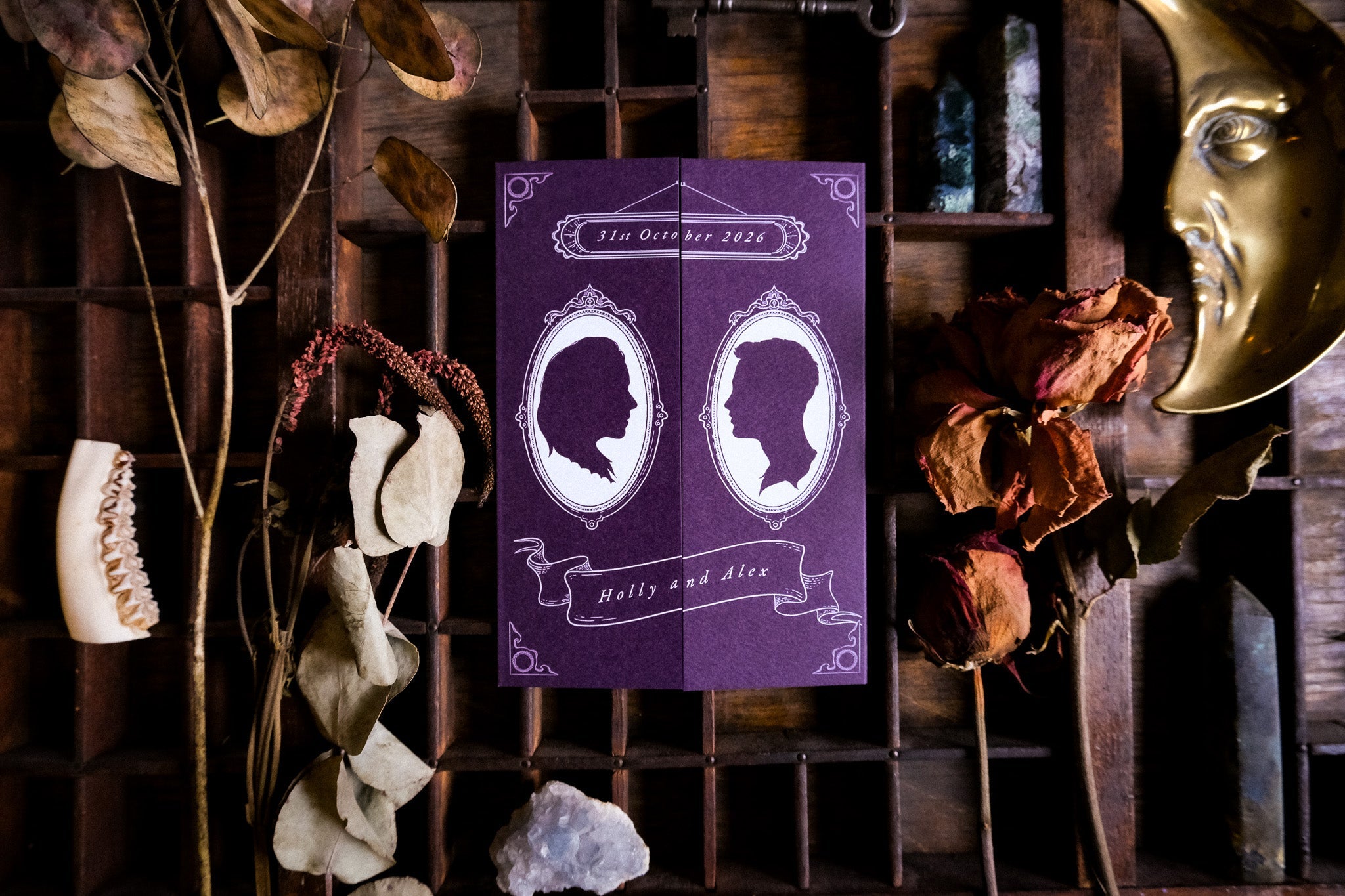 Luxury gatefold wedding stationery with hand-drawn silhouette, celestial details, dried florals, crystal, and crescent moon accents.