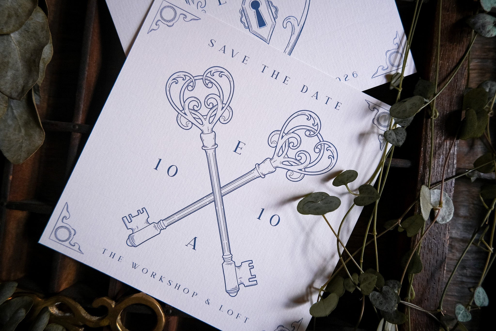 Luxury vintage save the date card with crossed skeleton keys and elegant illustrations on a rustic backdrop, perfect for romantic UK weddings.