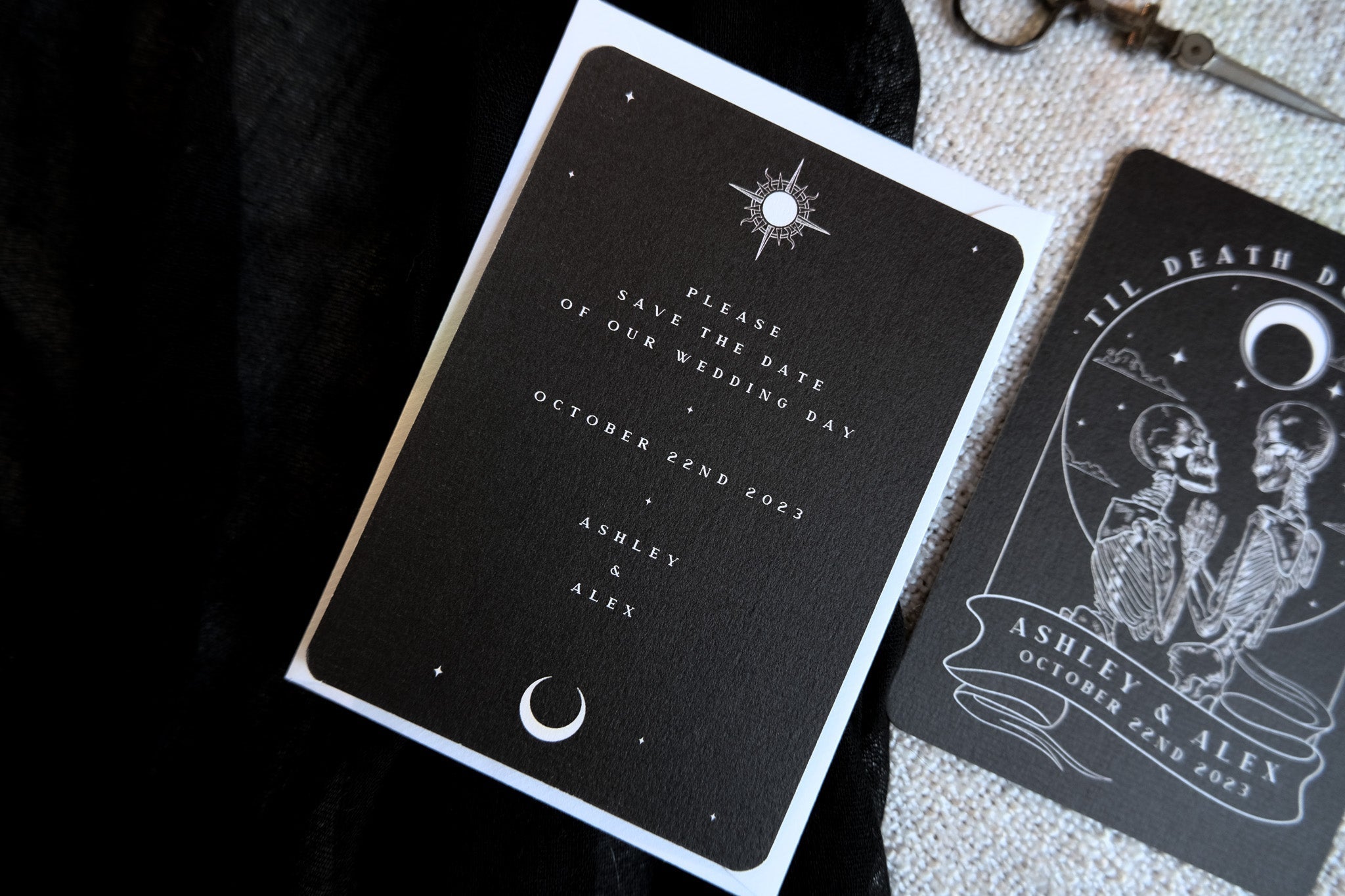 Luxury gothic wedding stationery with dramatic tarot-inspired design, featuring white celestial motifs on dark card, premium UK-made.