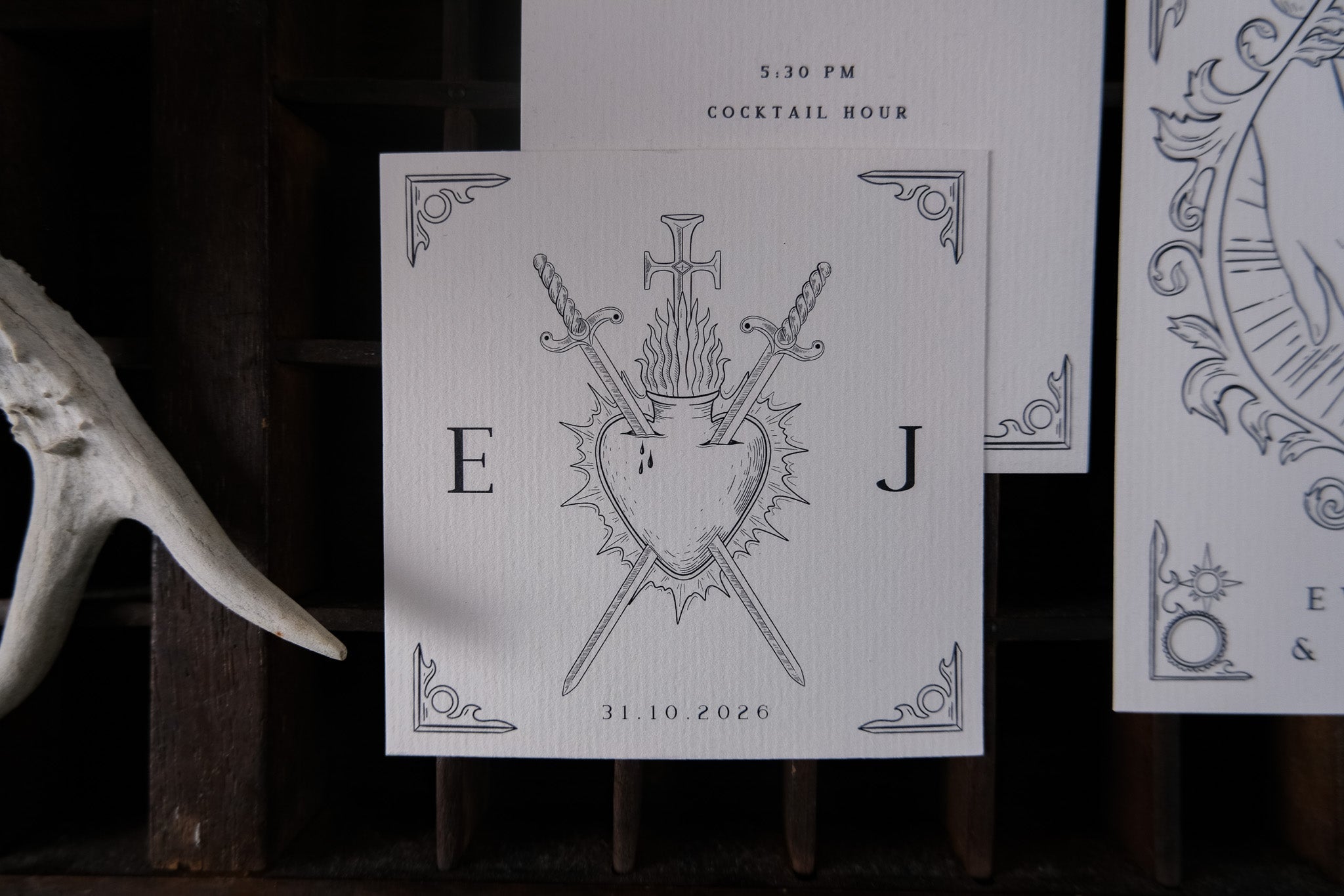 Luxury gothic wedding stationery suite featuring crossed swords, a flaming heart, ornate corners, and a dramatic vintage motif.