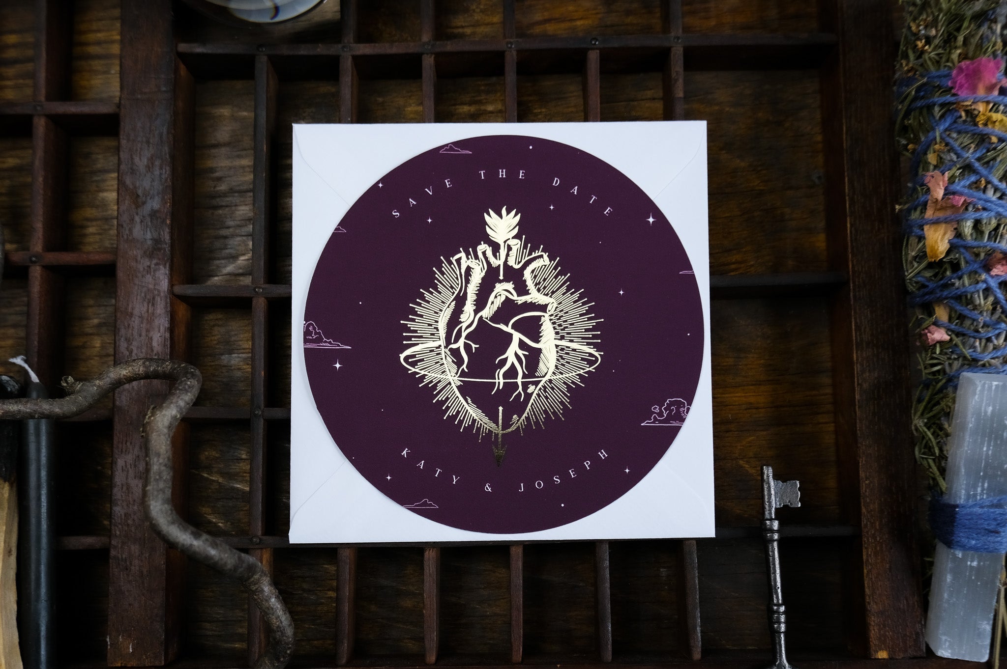 Luxury circular save the date card with gold foil botanical accents on deep purple, perfect for gothic romantic wedding stationery, UK.