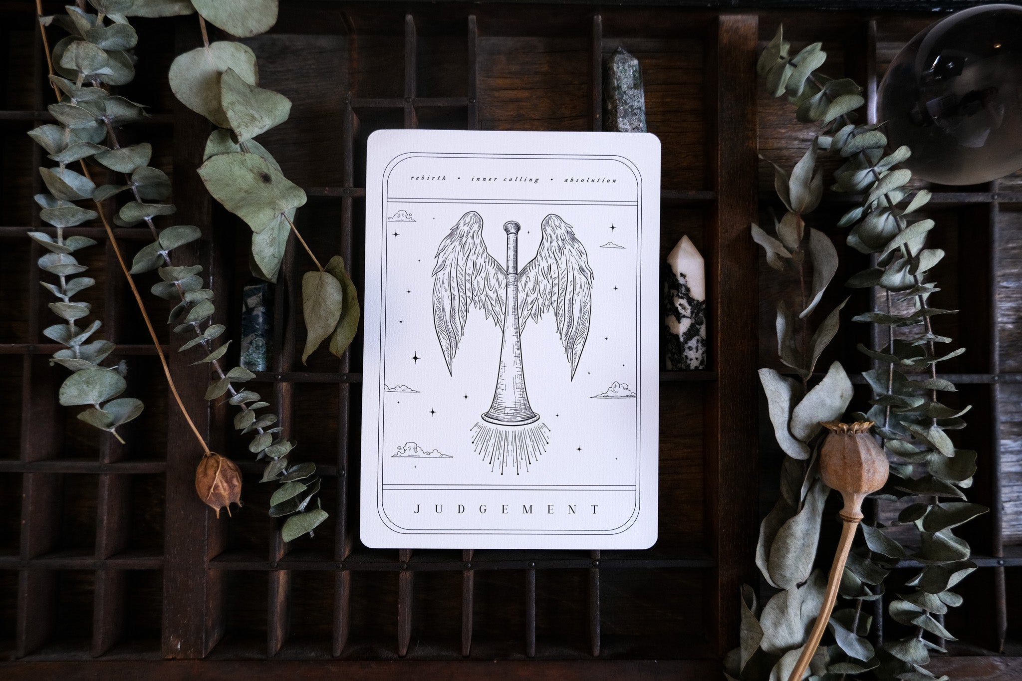 Luxury alternative wedding stationery with a gothic tarot-inspired design, featuring a winged trumpet, crystals, and vintage details.