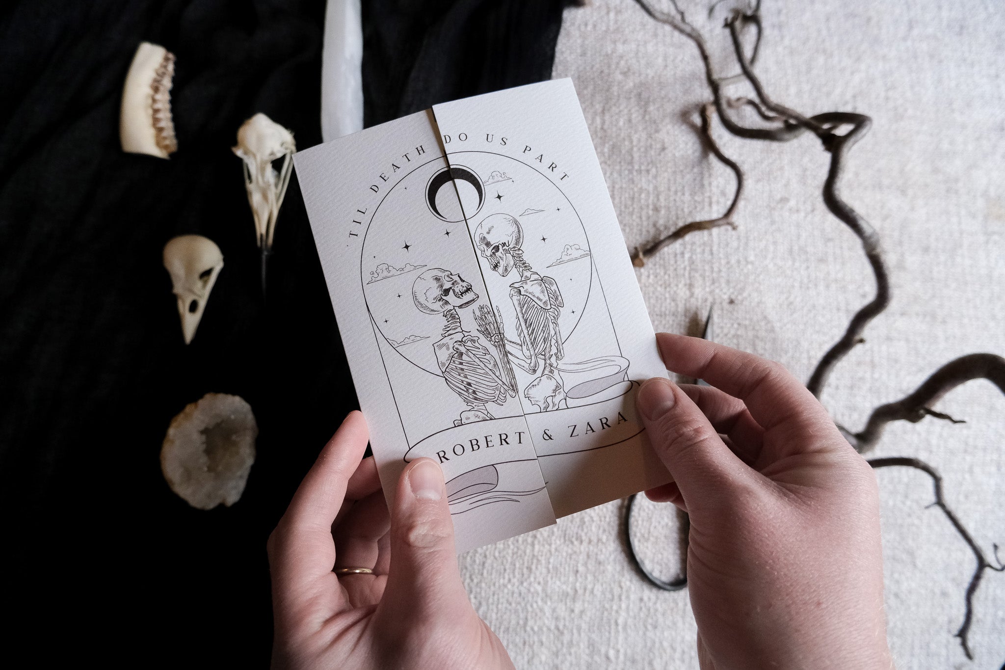 Skeleton Lovers & Bleeding Heart 'Til Death Do Us Part wedding invitation with gatefold design and white envelope.