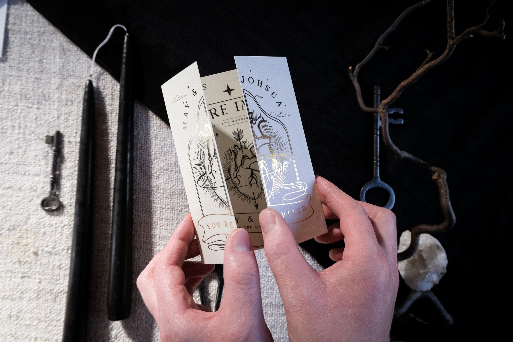 The Bleeding Heart foiled gatefold wedding invitation with shimmering design held open.