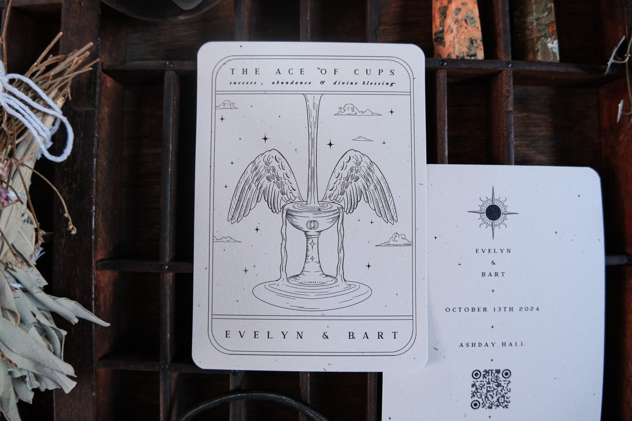 Ace of Cups Tarot Save the Date card with winged cup illustration, customizable color options, includes white envelopes.