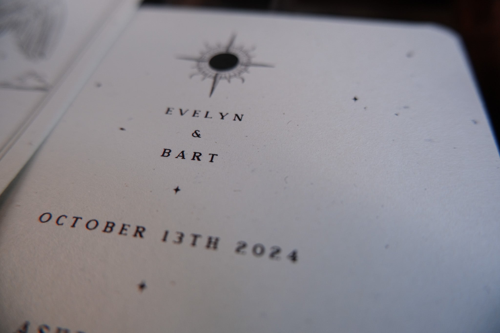 'Ace of Cups' Tarot Save the Date card with black text and compass design, featuring date and names.