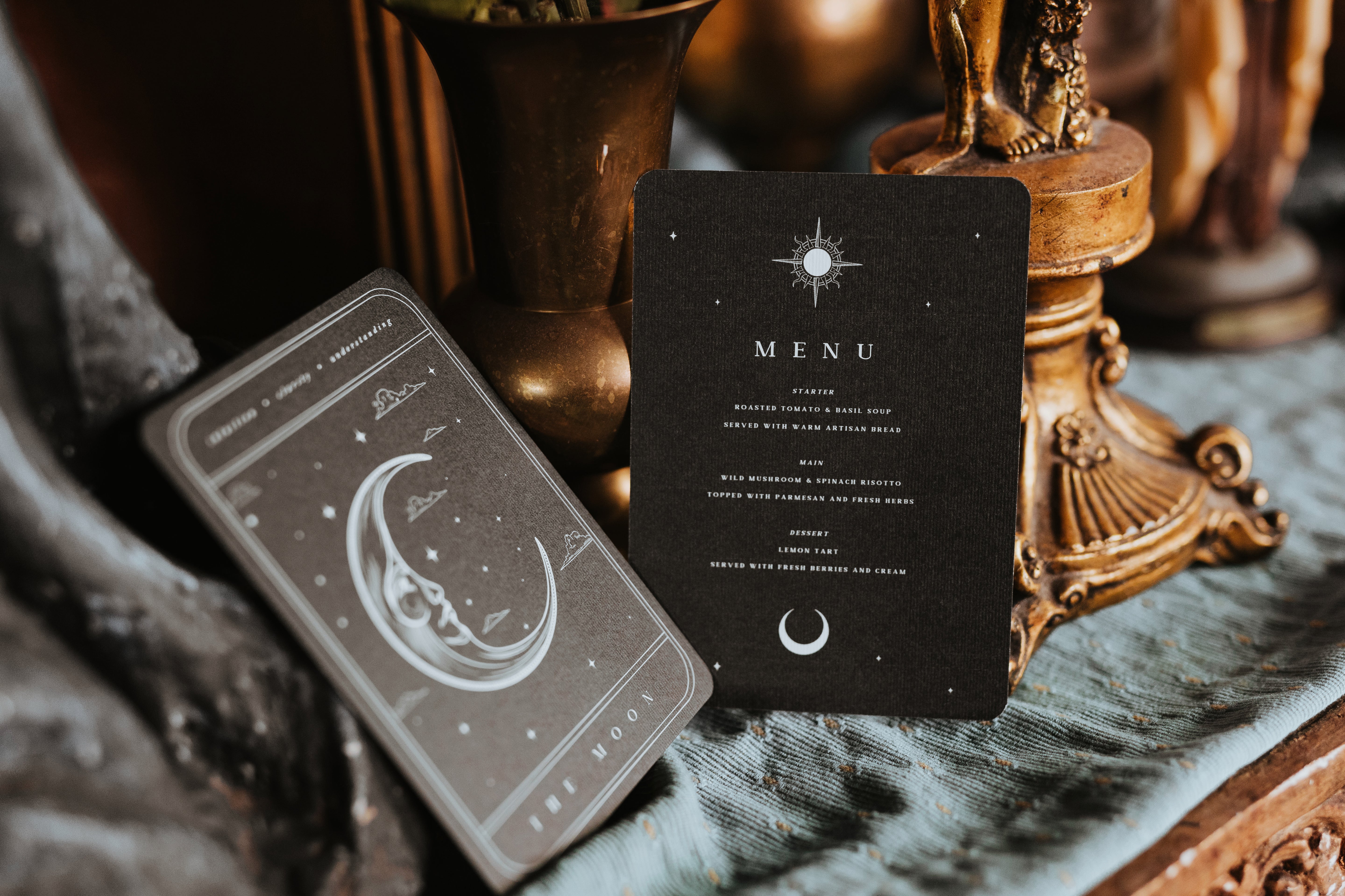 Tarot-inspired wedding menu card on a textured surface with decorative elements