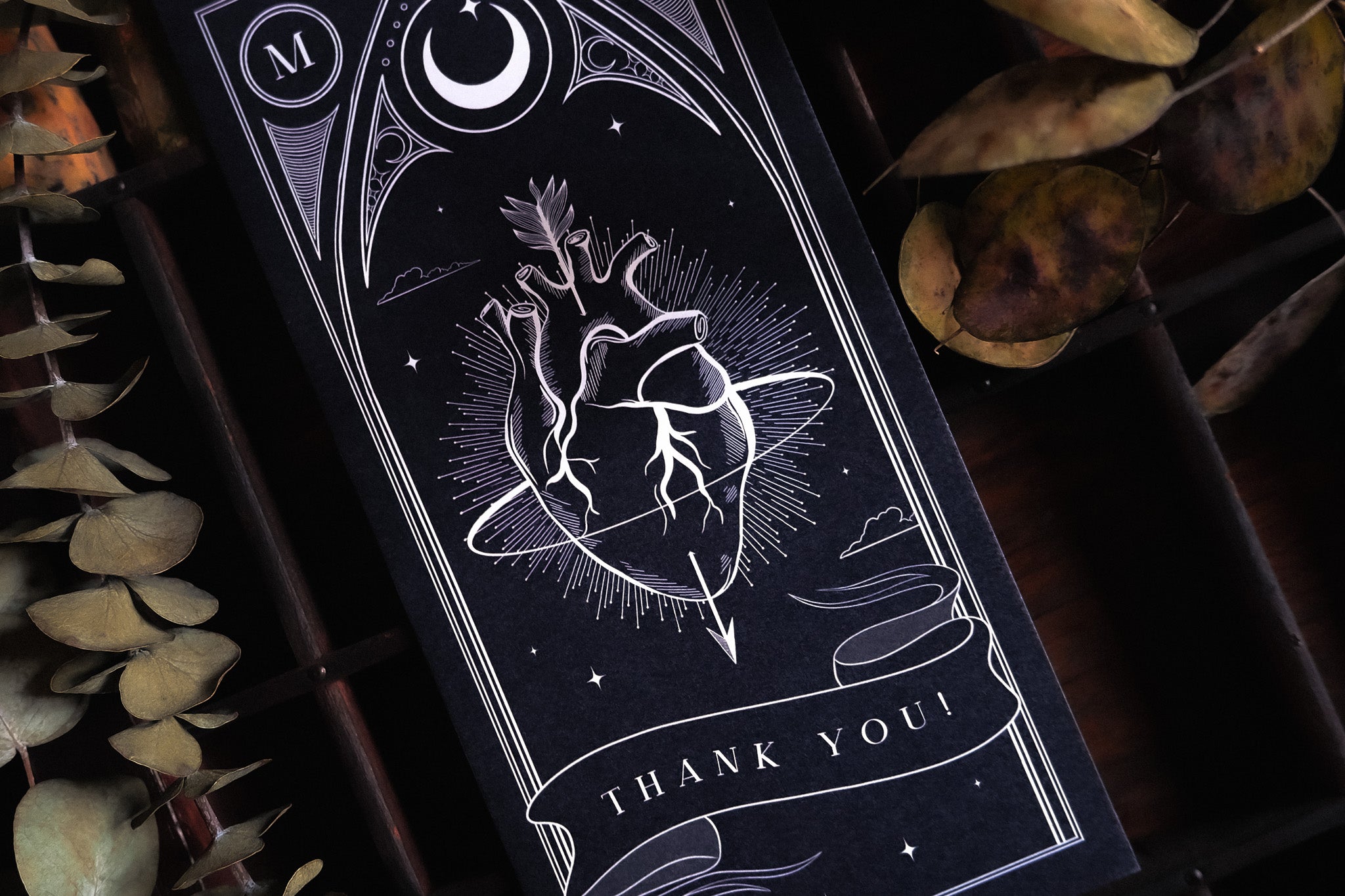 Luxury UK wedding thank you card in black, with mystical white anatomical heart and celestial accents, perfect for gothic weddings.