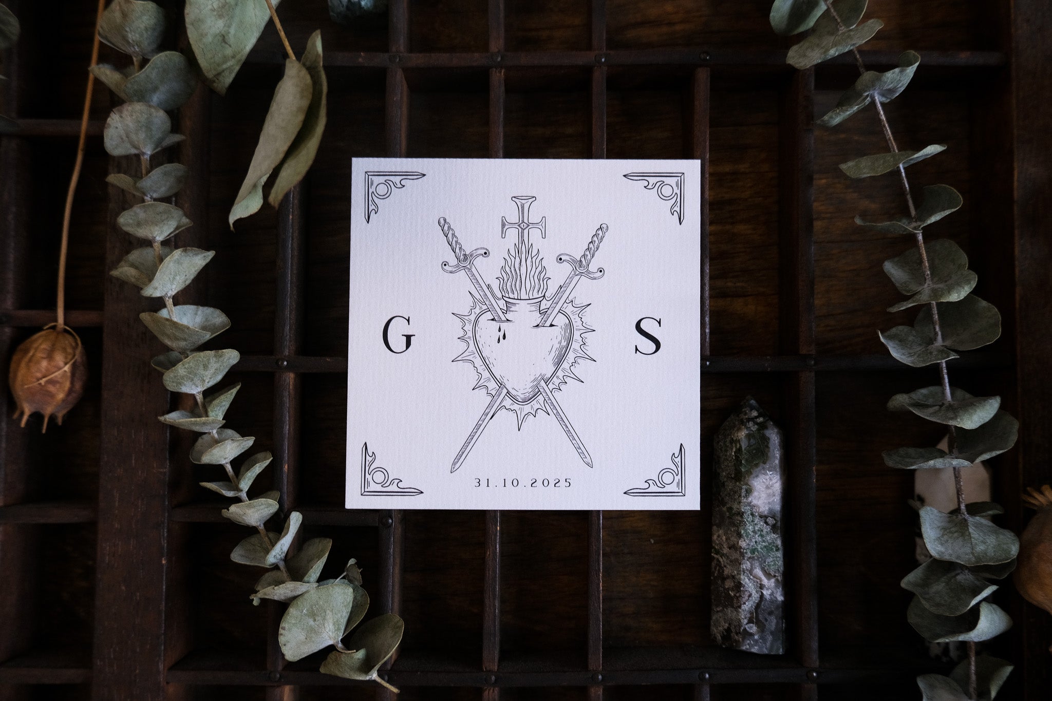 Premium UK wedding RSVP card with a vintage medieval shield, swords, and arrows, accented by dried greenery for a romantic touch.
