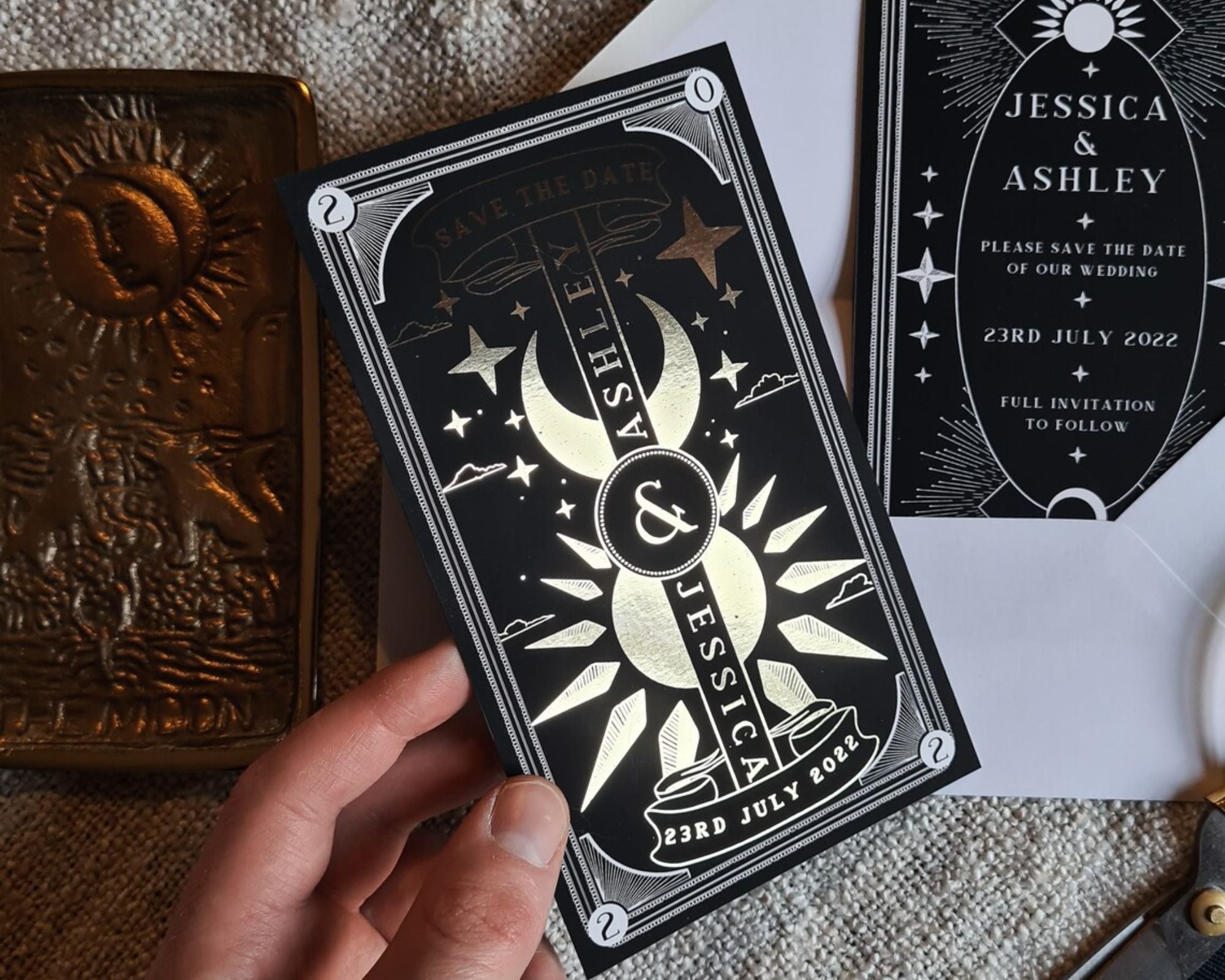 Dusk & Dawn foiled Save the Date card with sun and moon celestial design on velvet soft-touch card
