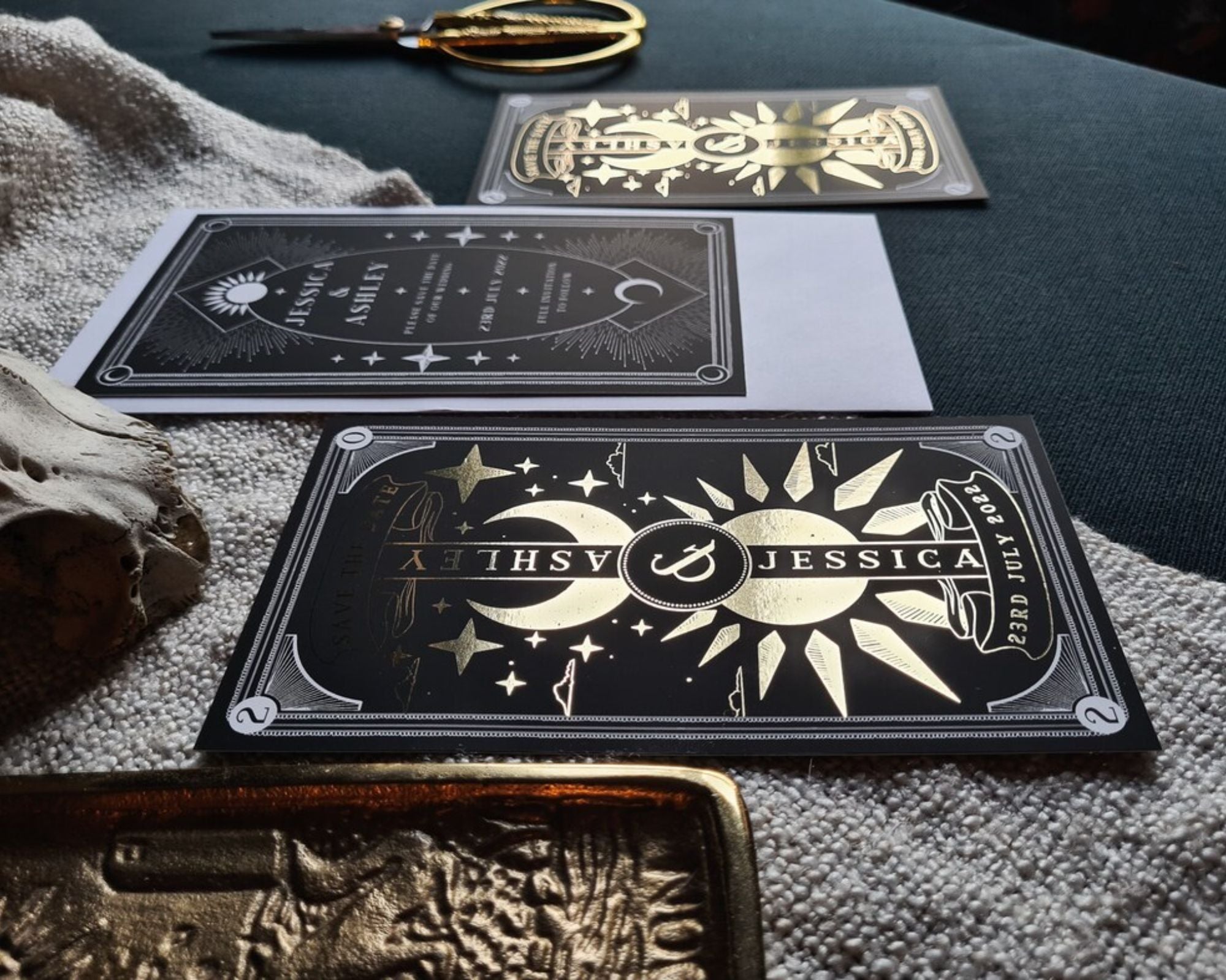 Dusk and Dawn foiled save the date card with celestial sun and moon design on velvet soft-touch card