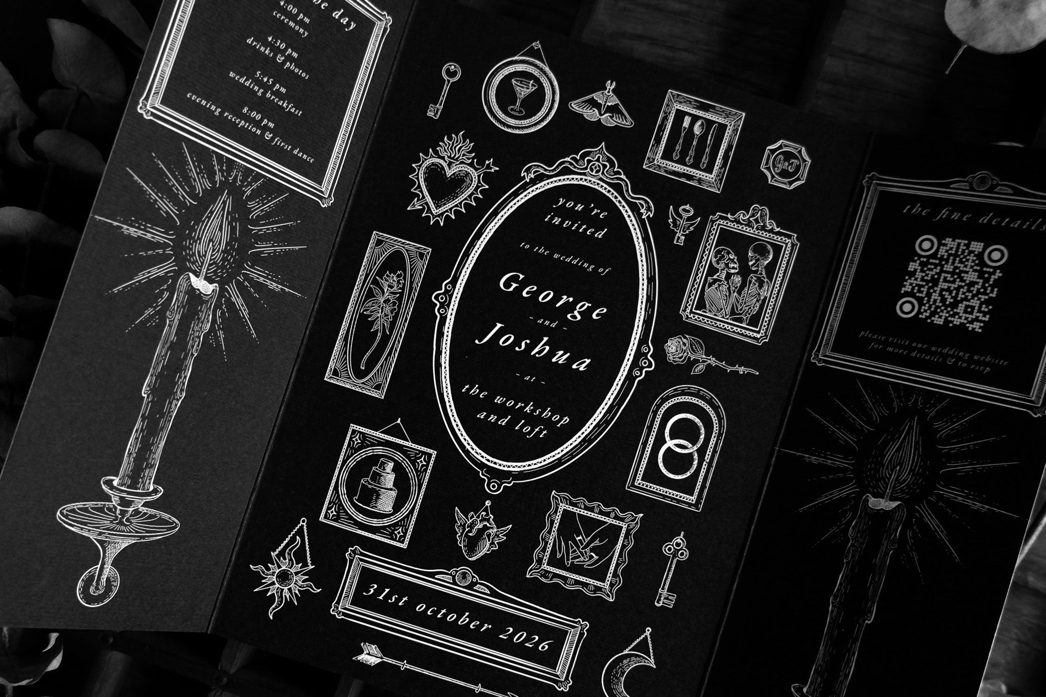 Luxury gatefold wedding invitation featuring dramatic black-and-white gothic motifs—candle, key, potion bottles, celestial heart.