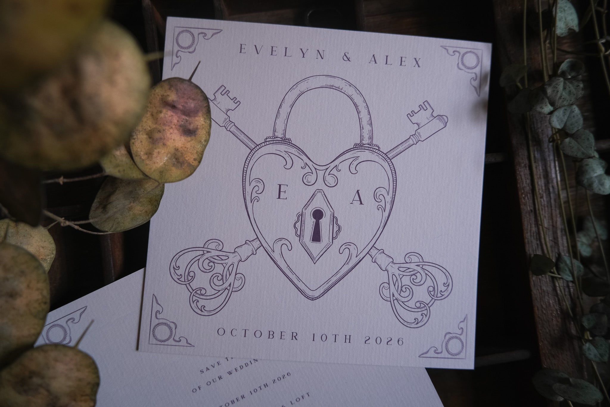 Luxury vintage save the date card with a heart padlock and ornate keys, featuring dramatic foil accents on premium textured card.