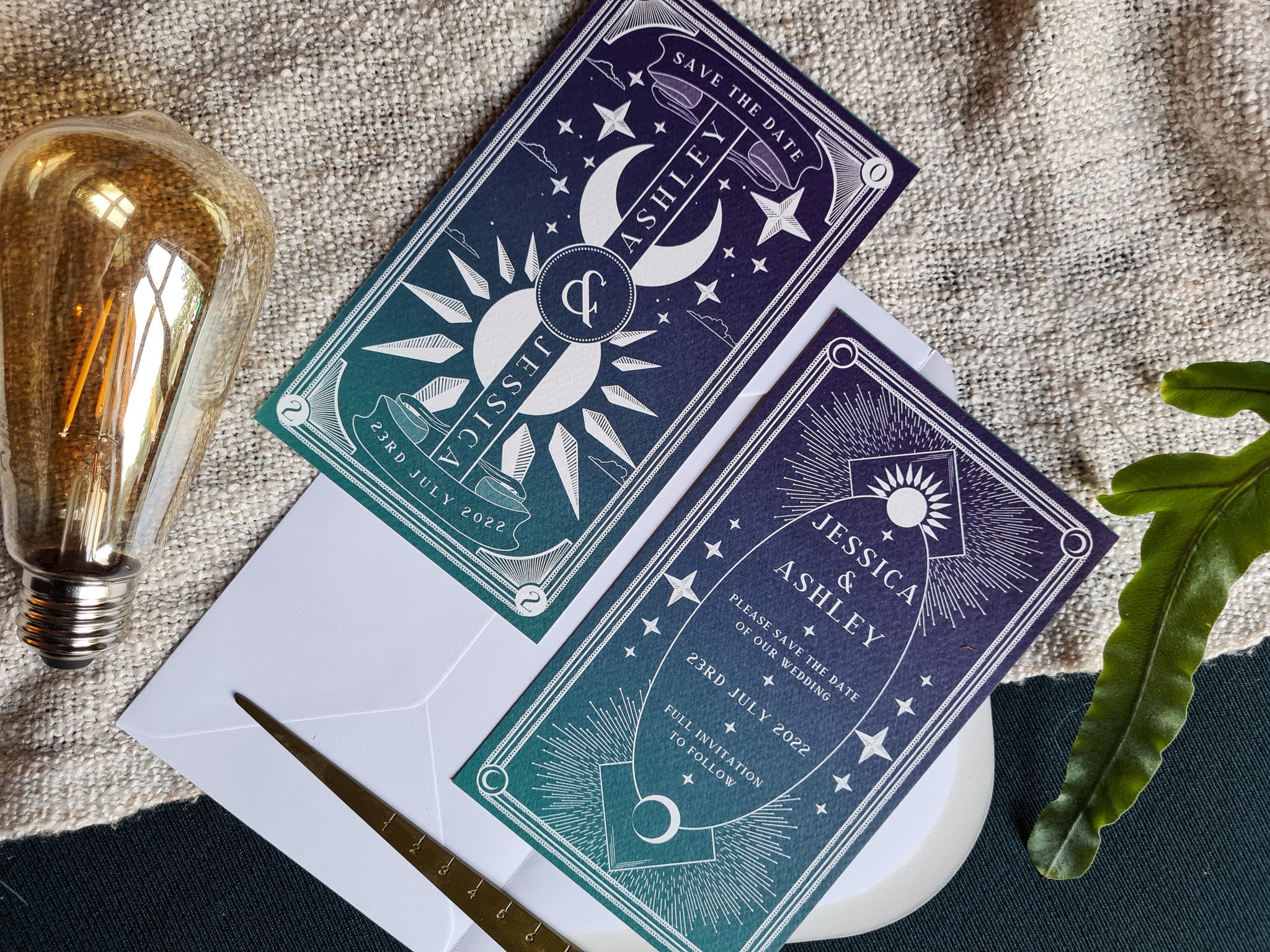 'Dusk & Dawn' Tarot themed save the date cards with white envelopes on textured background.