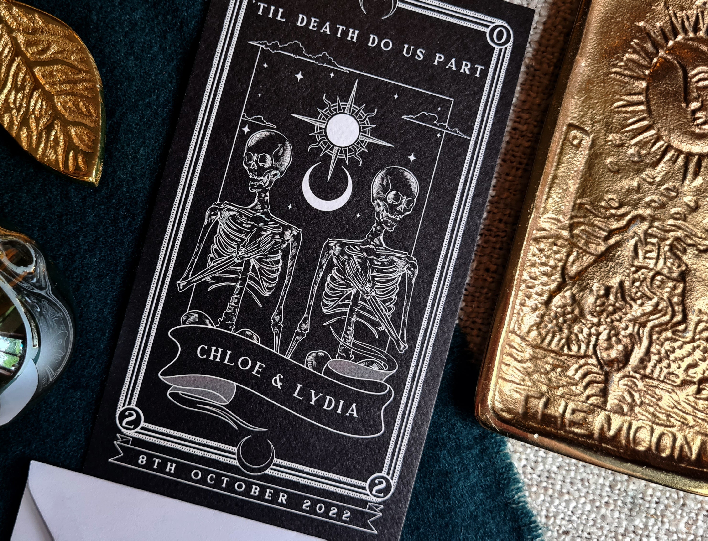 Tarot-themed save the date card with skeletons and celestial design.