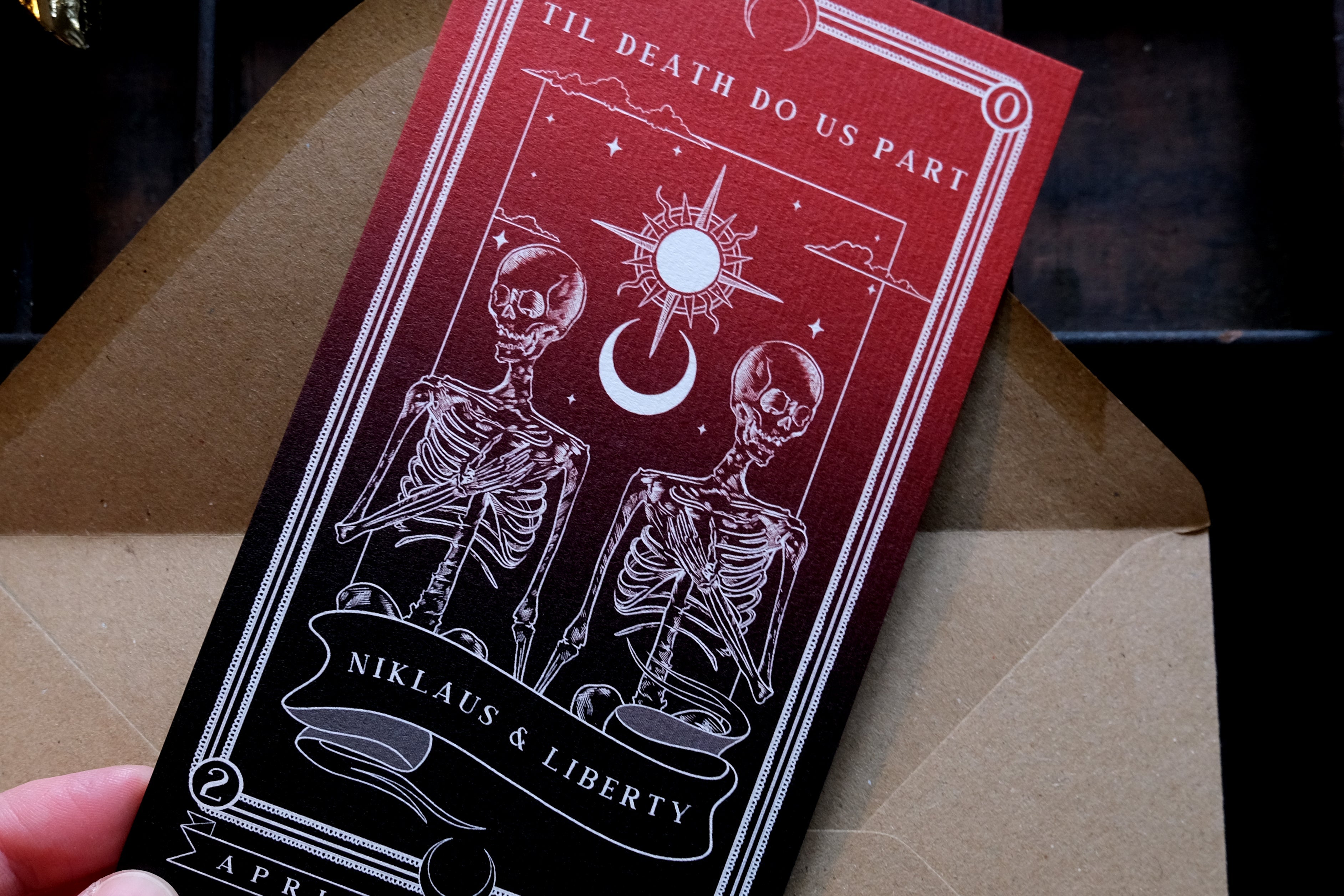 Tarot-themed save the date card with skeletons and celestial design.