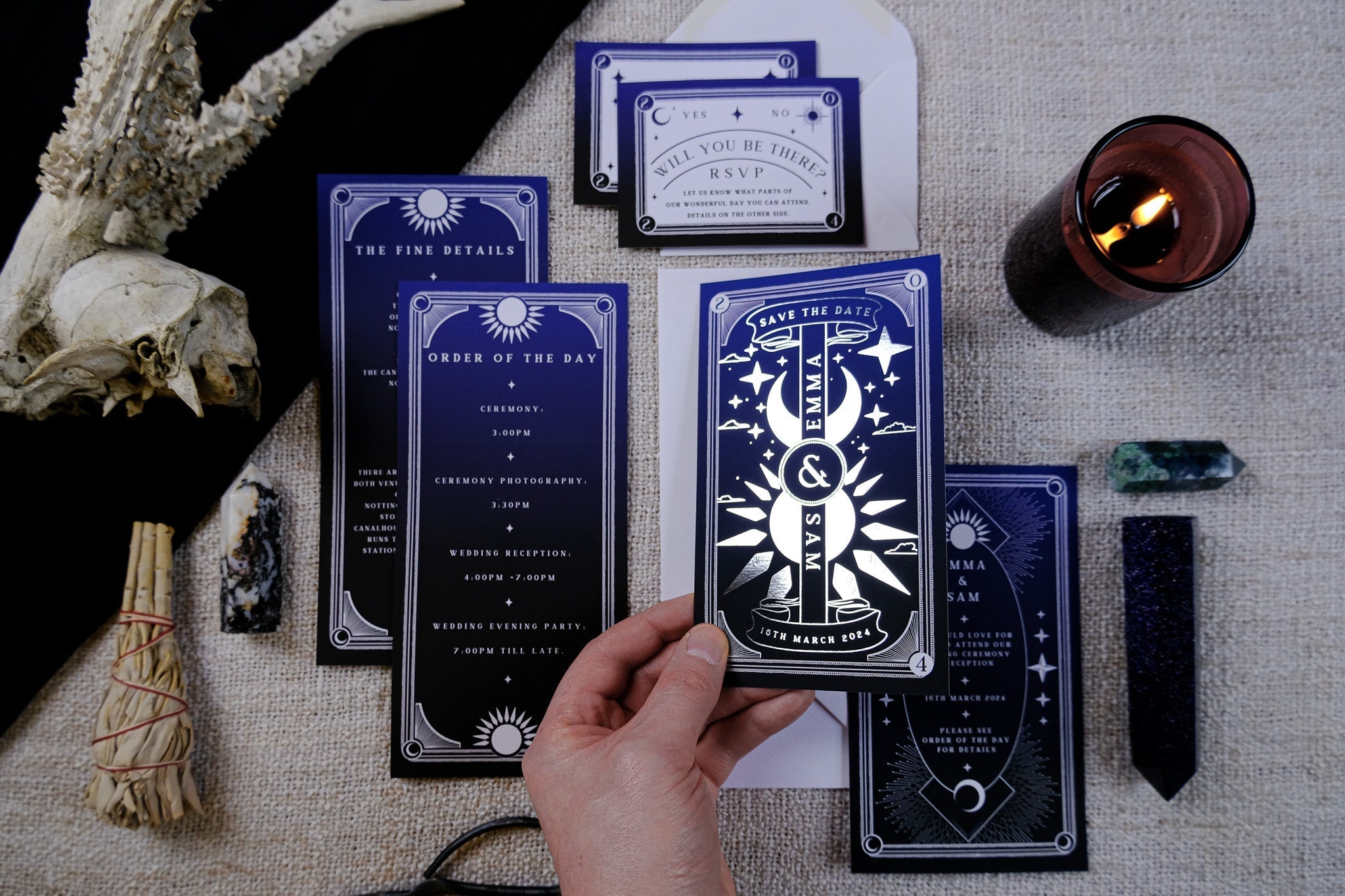 'Dusk & Dawn' Foiled Tarot Card 3 Piece Invitation Suite displayed with candle and decorative items.