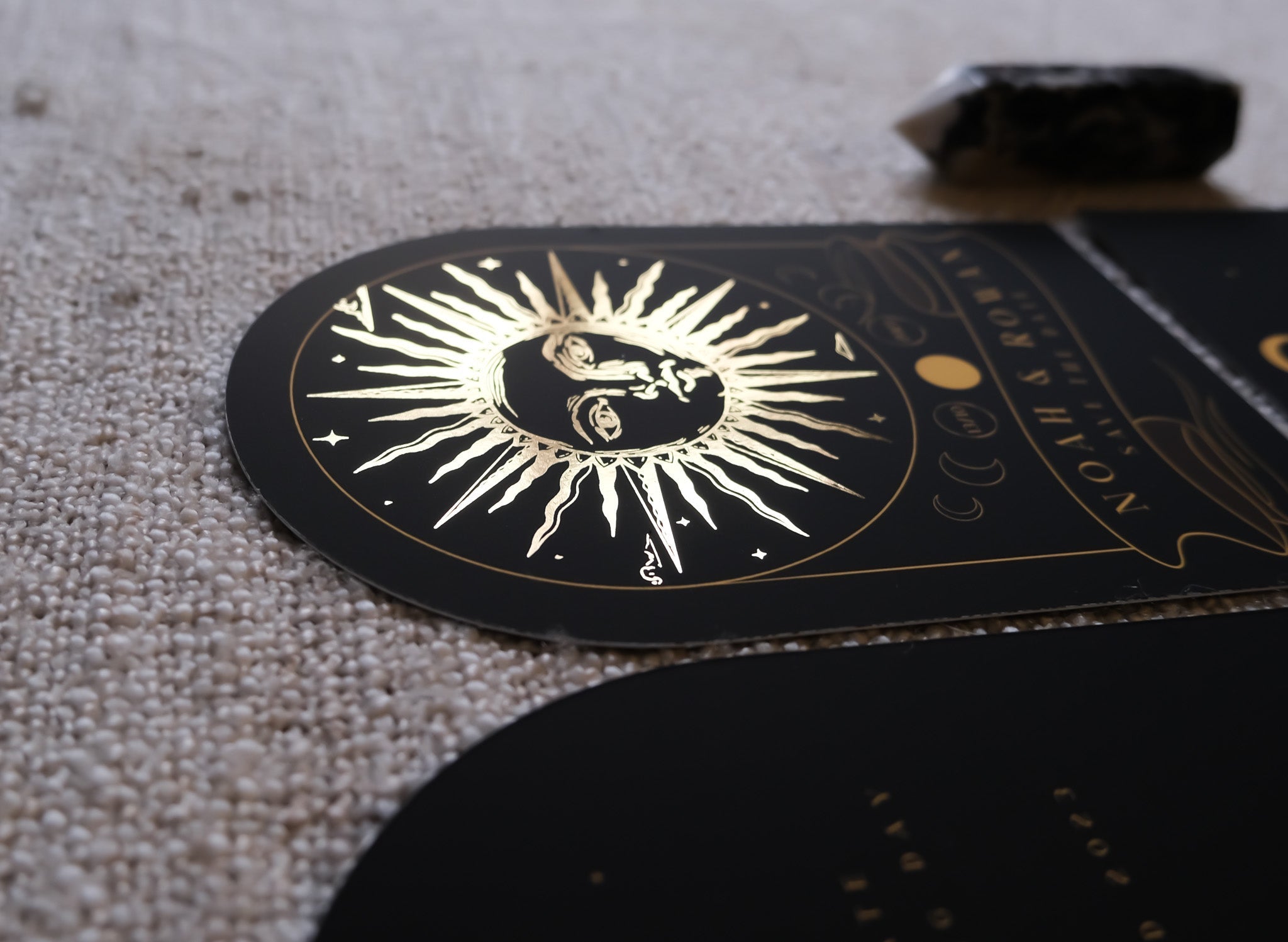 The Sun Tarot Arched Foiled Save The Date Card with gold foil detailing on a black background.