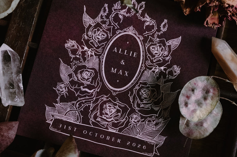 Luxury UK wedding stationery save the date card with dark, dramatic floral design, white roses, and gothic-inspired details.