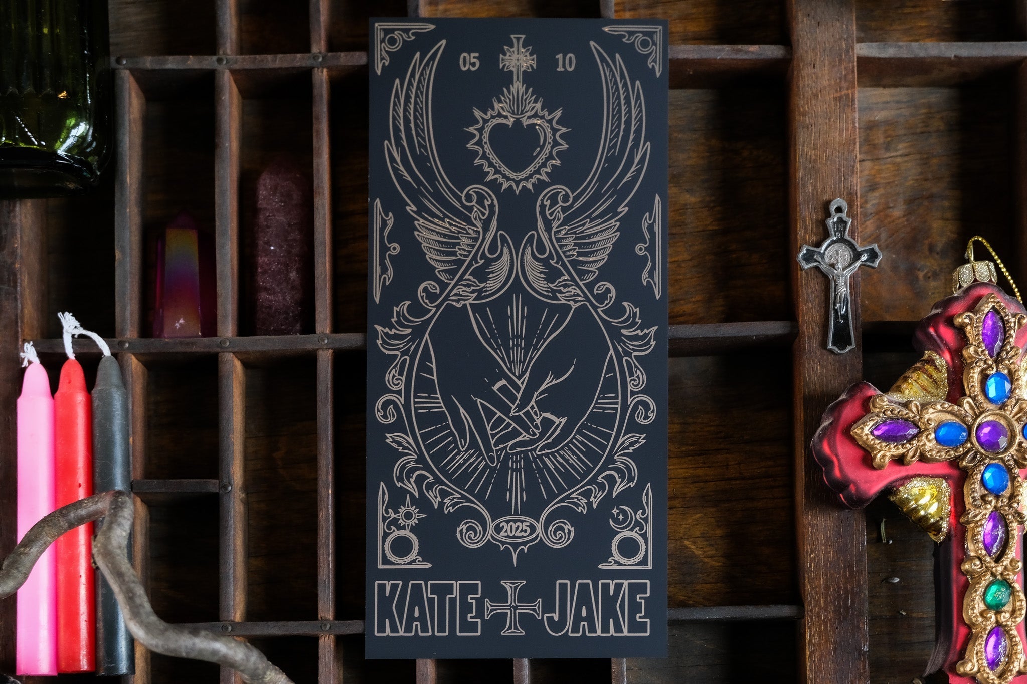 Luxury UK wedding save the dates with a dramatic vintage gothic design, foil accents, bleeding heart and swords, candles, and jeweled crosses.