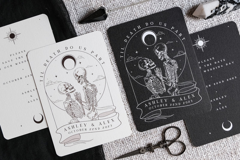 Luxury gothic wedding stationery with a dramatic tarot-inspired skeleton couple beneath a celestial moon, printed on textured fabric.