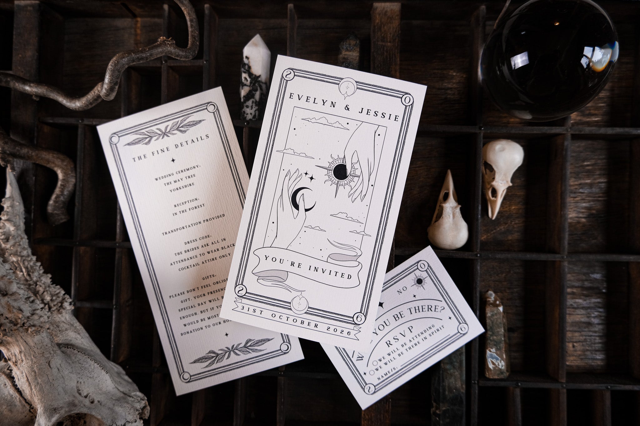Luxury UK wedding stationery suite with a mystical, gothic tarot design in black and white, featuring birds, skulls, and botanicals.
