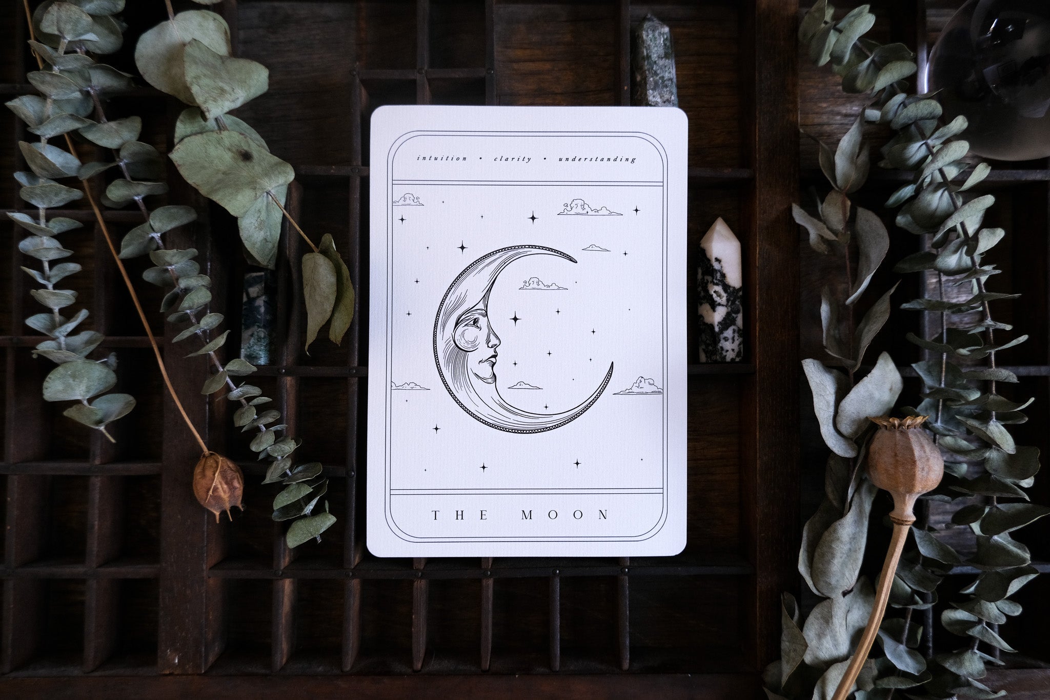 Luxury gothic wedding stationery card with a celestial crescent moon, stars, and clouds in a mystical tarot-inspired design.
