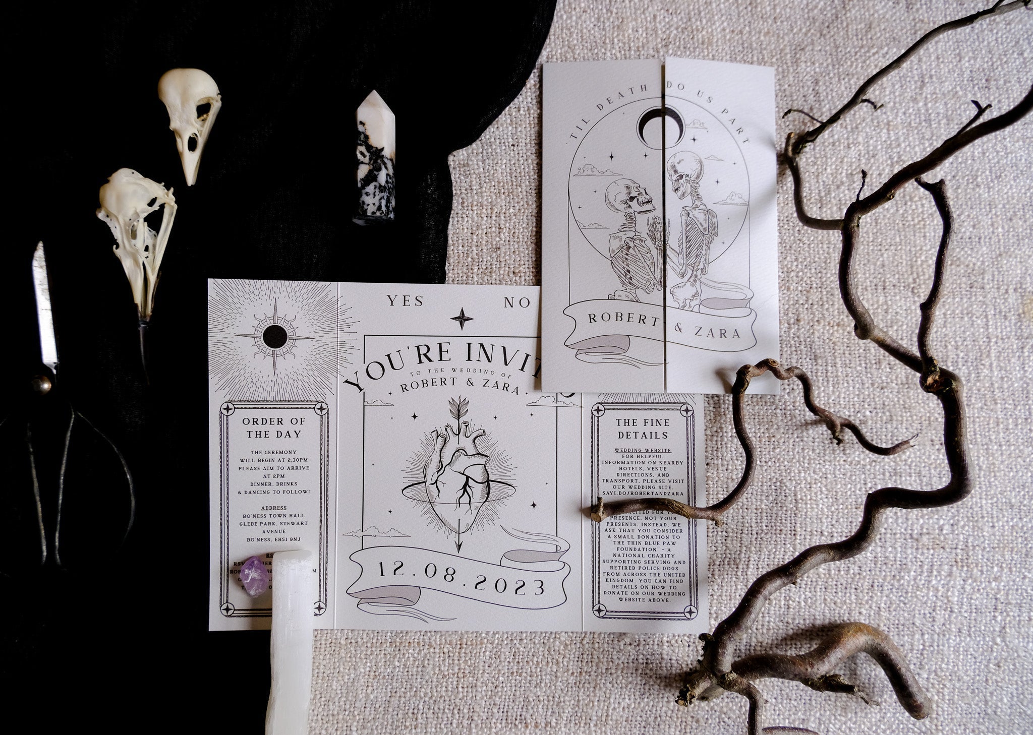 Gatefold wedding invitation with skeleton lovers and bleeding heart gothic design titled 'Til Death Do Us Part' on matte textured card