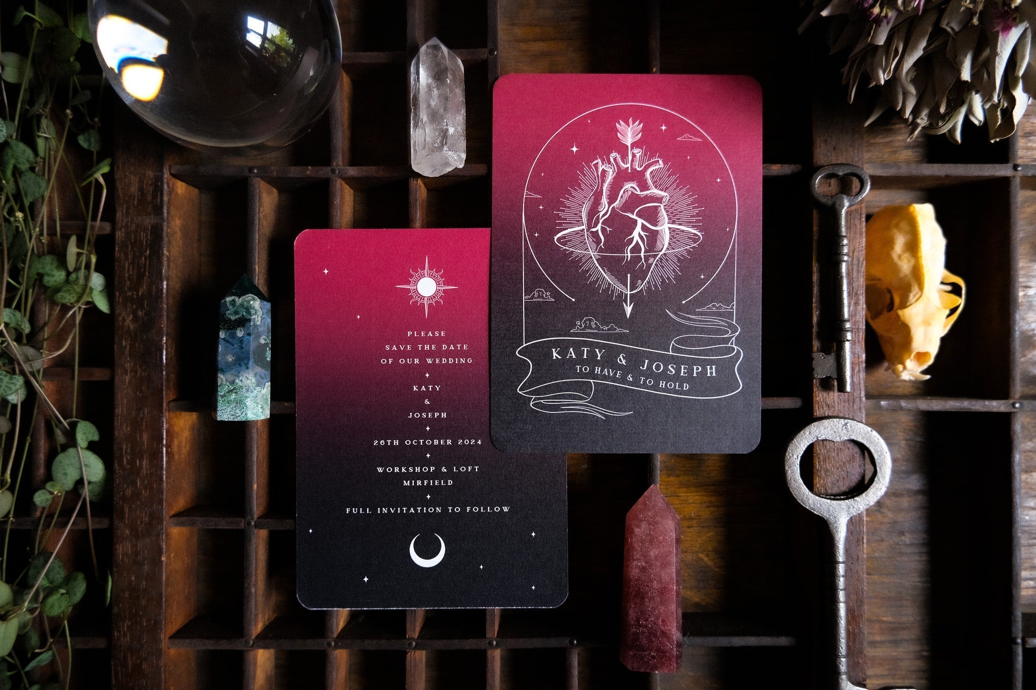 Luxury gothic wedding stationery featuring anatomical heart designs on A6 cards, styled with crystals, vintage key, and dried florals.