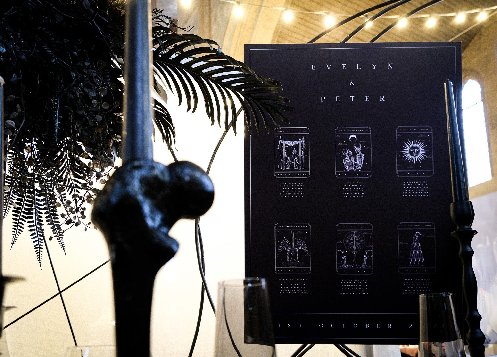 Luxury personalised wedding seating chart with vintage tarot illustrations, black candles, foliage, and mystical gothic décor.