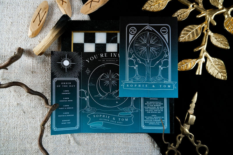 Luxury celestial wedding invitation set in deep blue and black with gothic moon, star, and zodiac foil details for a mystical UK wedding.