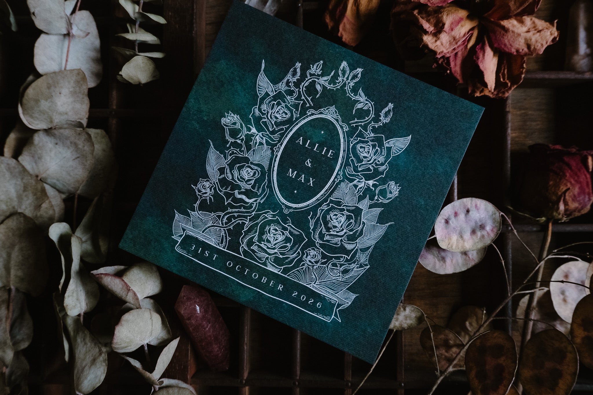 Luxury UK wedding stationery featuring a dark green gothic floral design and white rose line art, perfect for alternative celebrations.