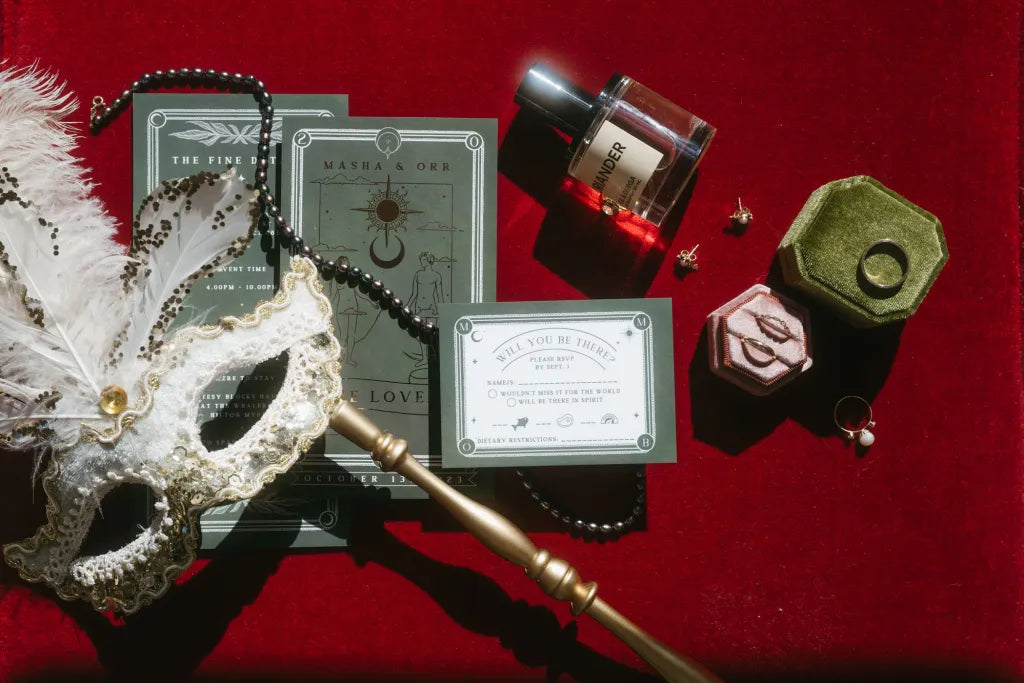 Luxury UK wedding stationery with a dramatic, vintage vibe: green cards, gold foil details, and celestial accents on red velvet.