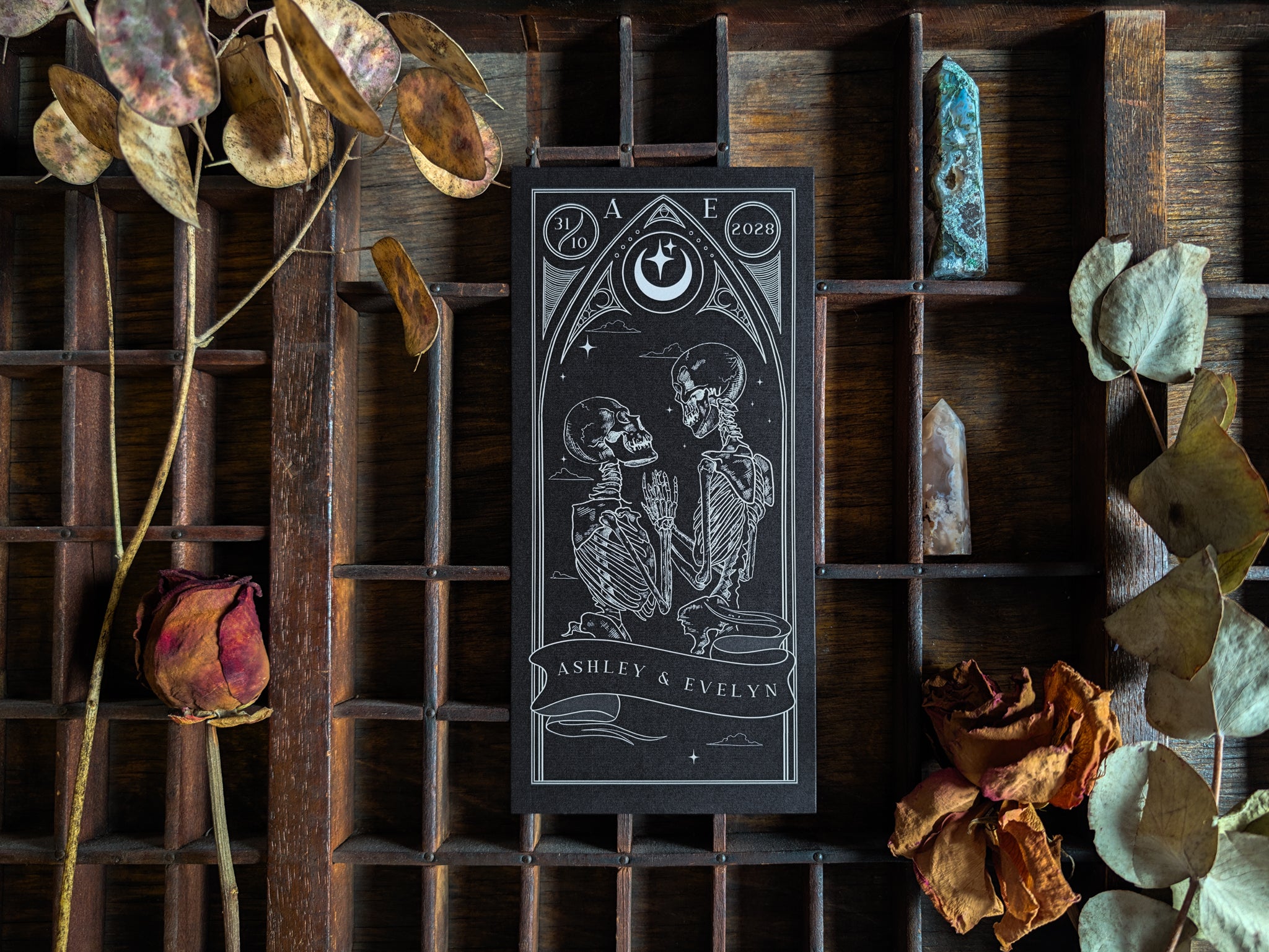 The Skeleton Lovers Tarot save the date card in jet black with celestial detailing.