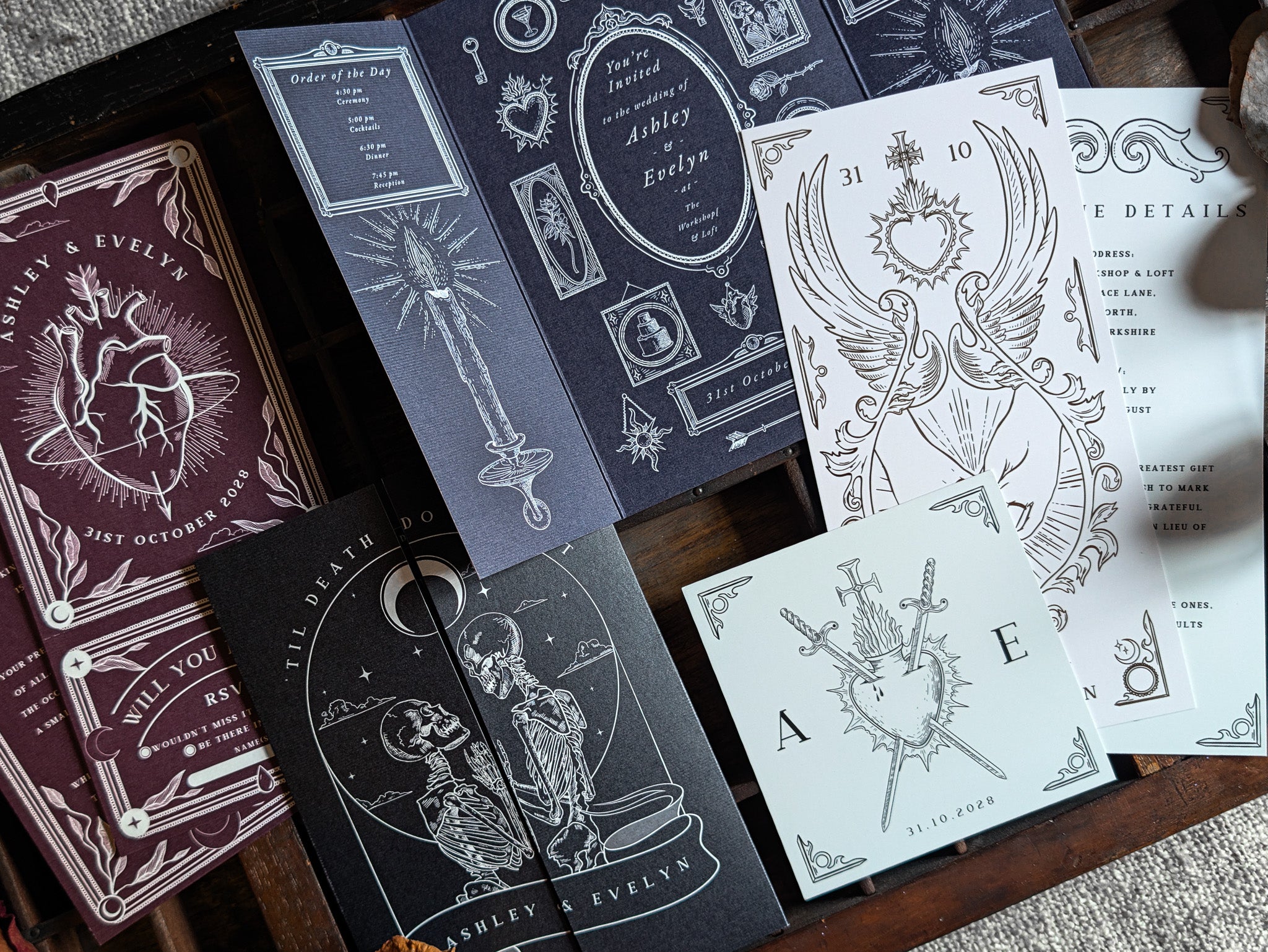A luxury sample pack of UK wedding stationery featuring a gothic and celestial-inspired invitation suite. The collection showcases dramatic black and white illustrations of hearts, swords, vintage constellations, and mystical celestial motifs on premium textured cardstock. Ideal for couples seeking personalised, alternative wedding invitations with a romantic yet edgy aesthetic.