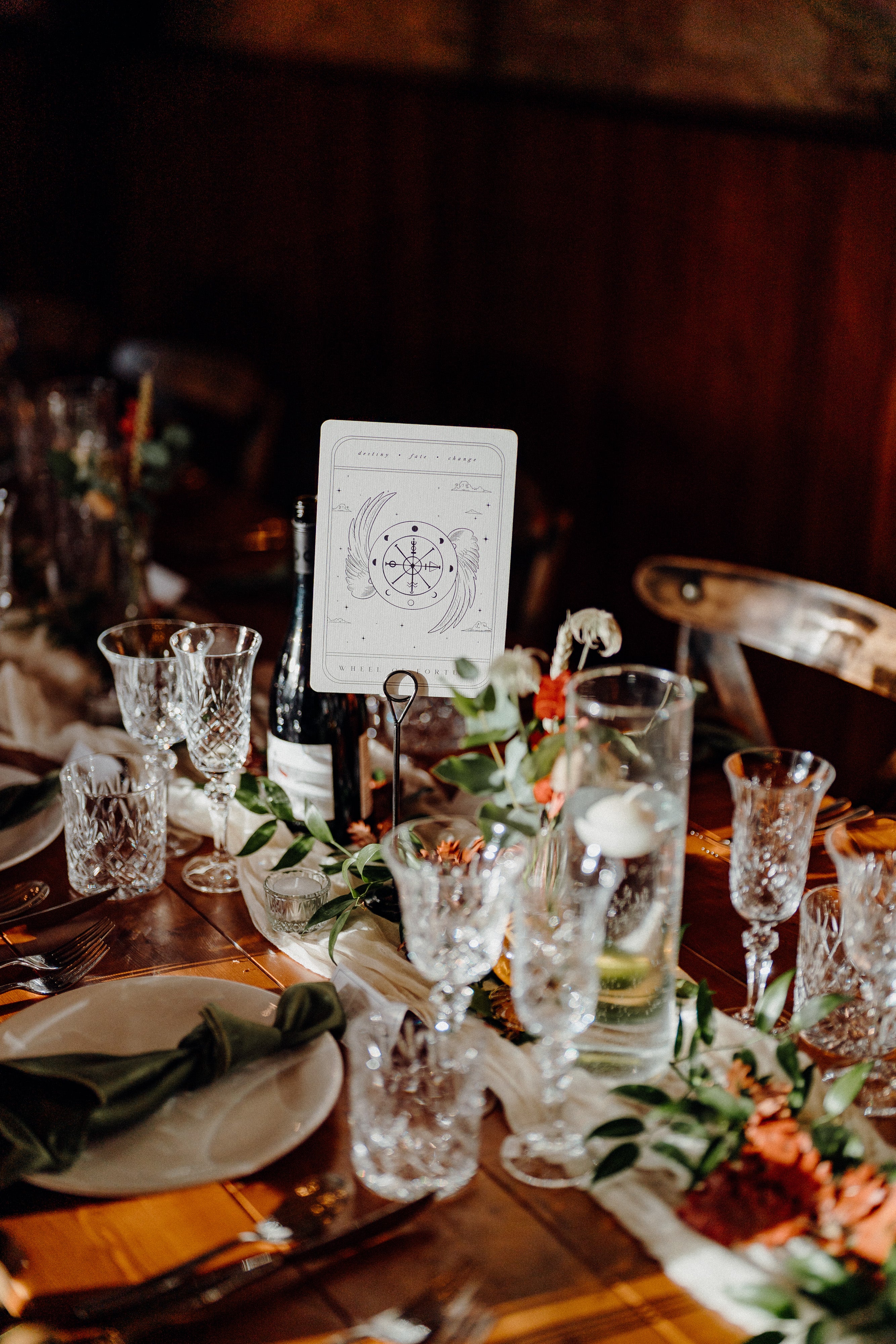 Luxury UK wedding stationery with celestial motifs and foil details is displayed as a dramatic, romantic table centerpiece.