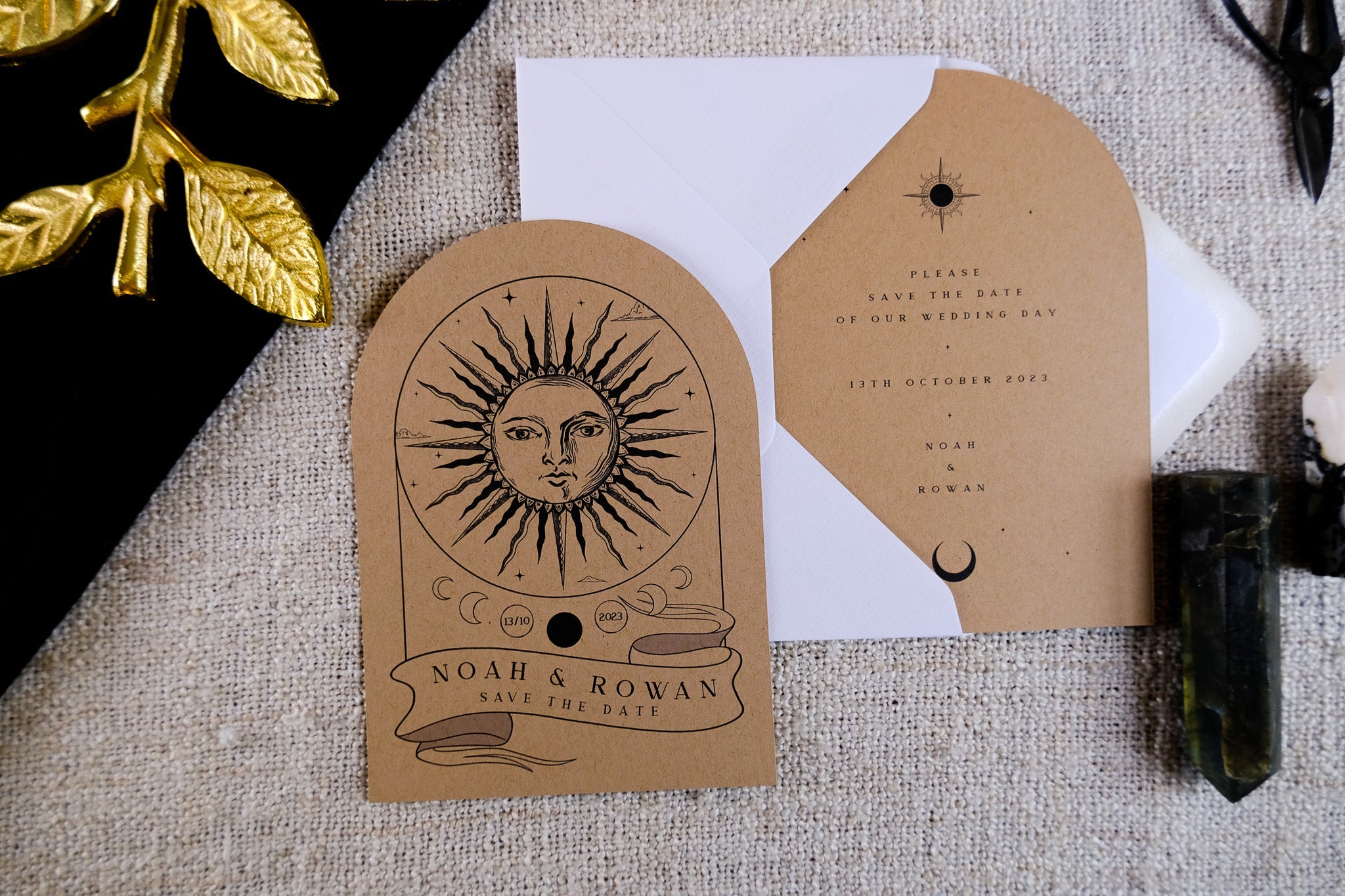 Boho save the date card on kraft brown with celestial sun motif, luxe textured finish, white envelope, and romantic vintage accents.