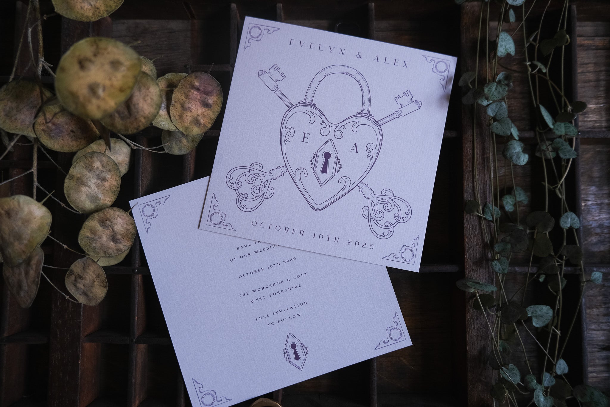 Luxury vintage wedding stationery save the date card featuring a heart padlock and skeleton key, styled with dried leaves for a romantic UK setting.