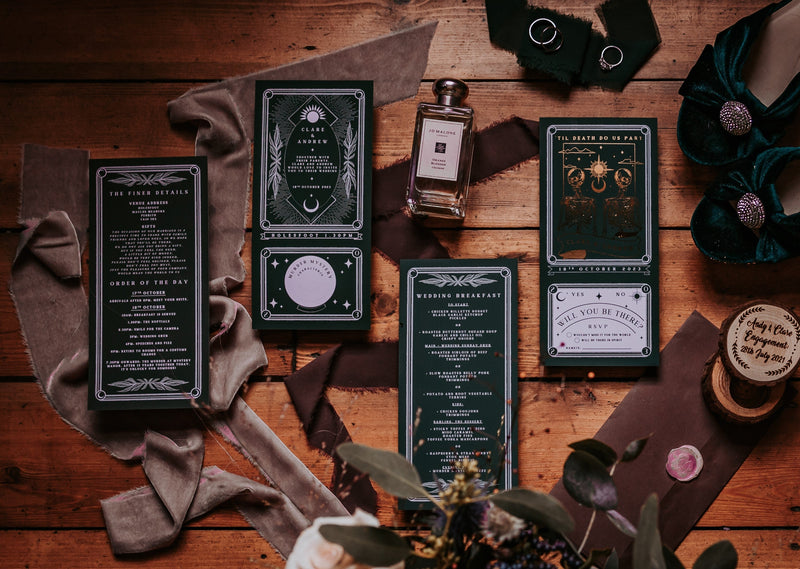 'Til Death Do Us Part' Foiled Tarot Full Invitation with RSVP on wooden table, featuring elegant design and white envelopes.