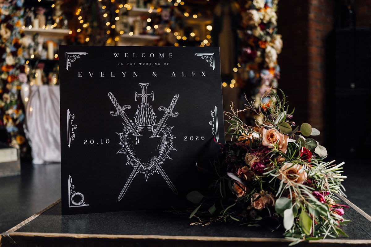 Personalised gothic wedding welcome board featuring white swords, shield motif, and romantic bouquet; premium UK stationery.