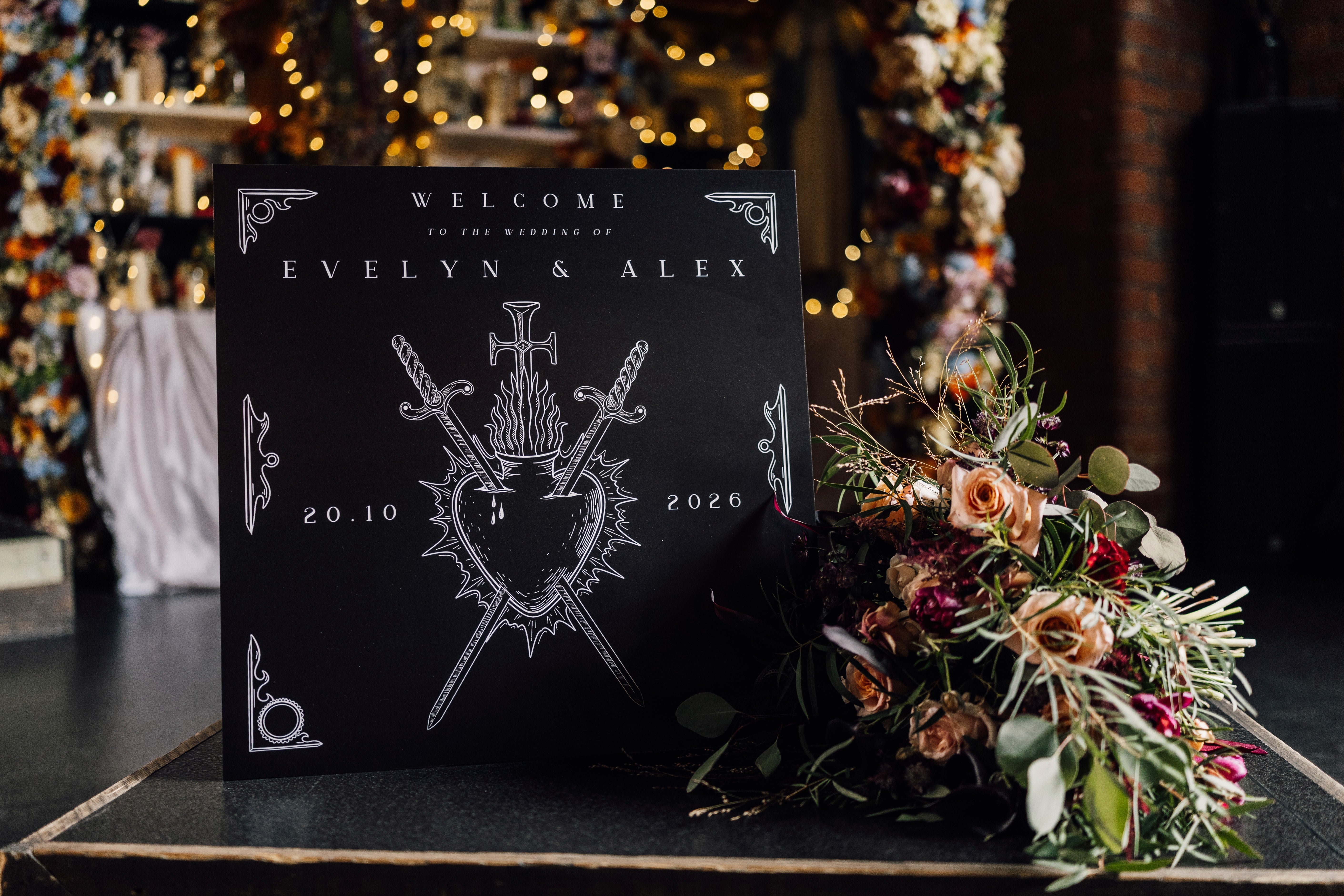 Personalised gothic wedding welcome board featuring white swords, shield motif, and romantic bouquet; premium UK stationery.