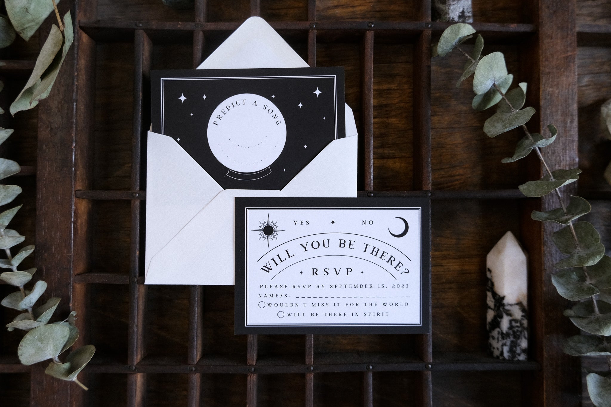 Luxury black and white gothic RSVP cards with celestial and mystical details, paired with a white envelope for dramatic UK weddings.