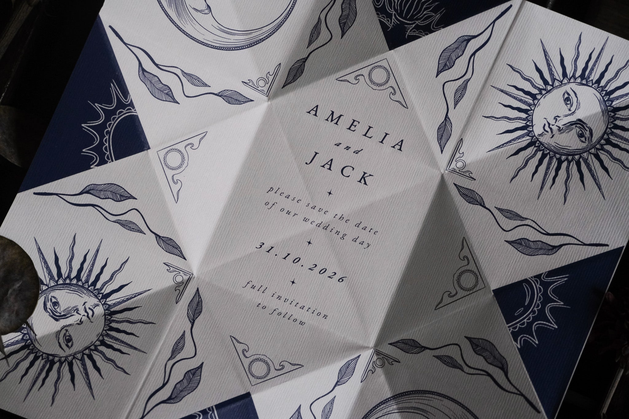 Luxury celestial-themed folding save the date with dramatic sun and moon art, vintage details, and premium UK wedding stationery finish.