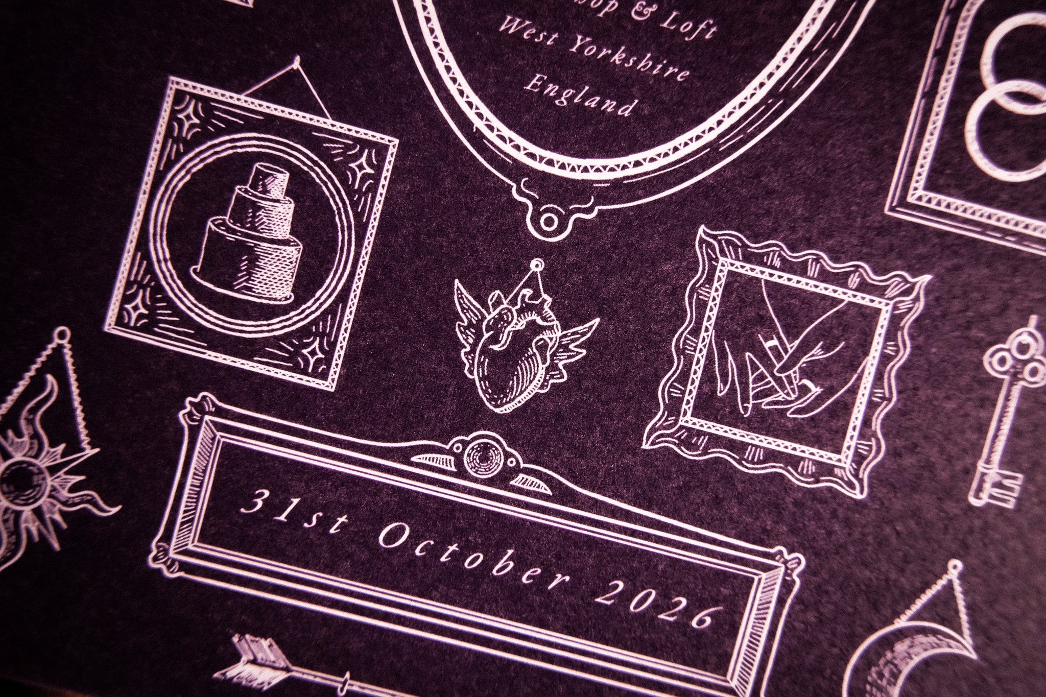 Luxury gatefold wedding invitation with vintage silhouettes, winged heart, cake, and utensils in a dramatic Victorian gothic style.