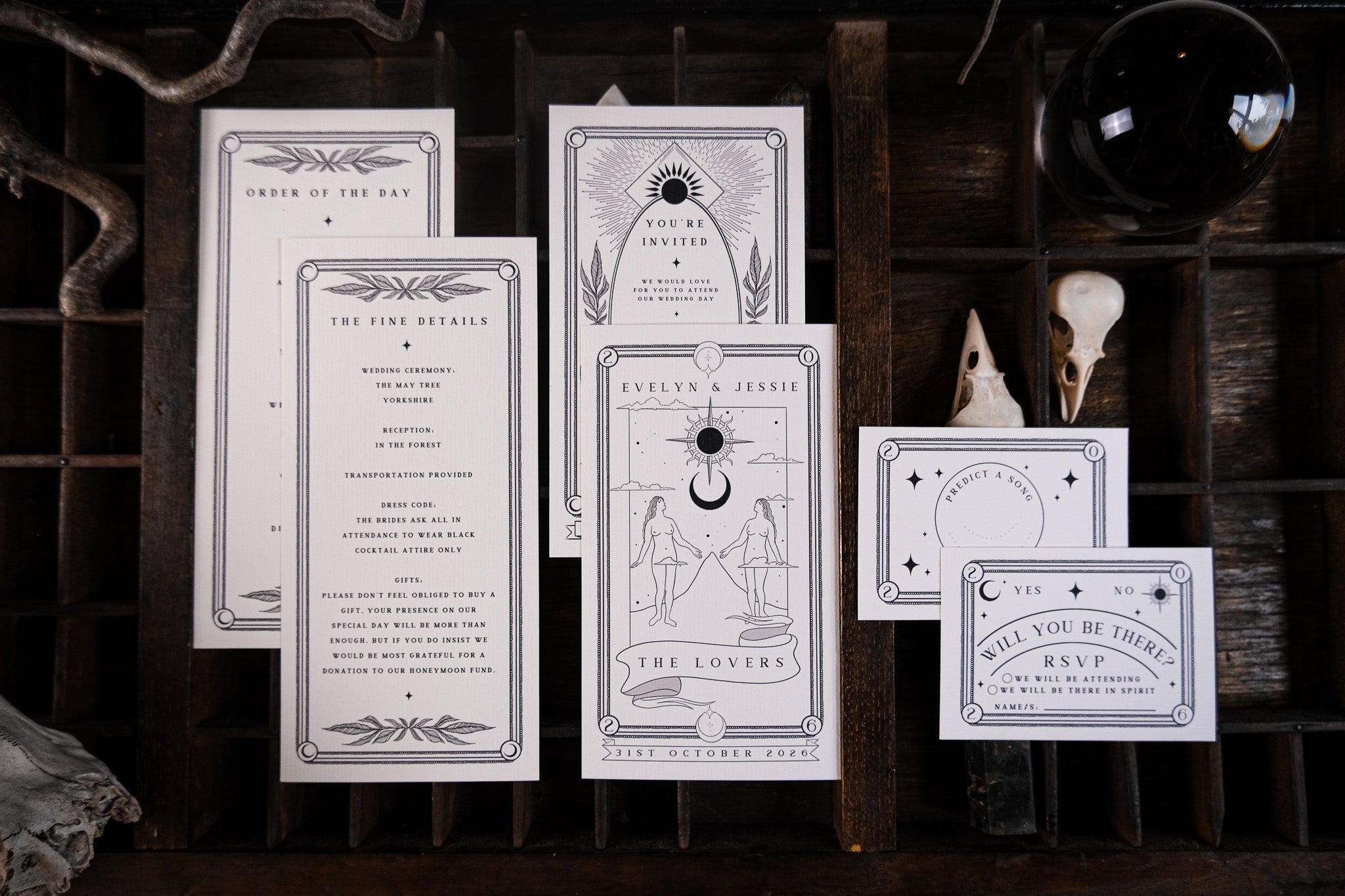 Luxury UK wedding stationery suite with gothic, celestial black and white designs, crystal ball motif, and mystical, romantic details.
