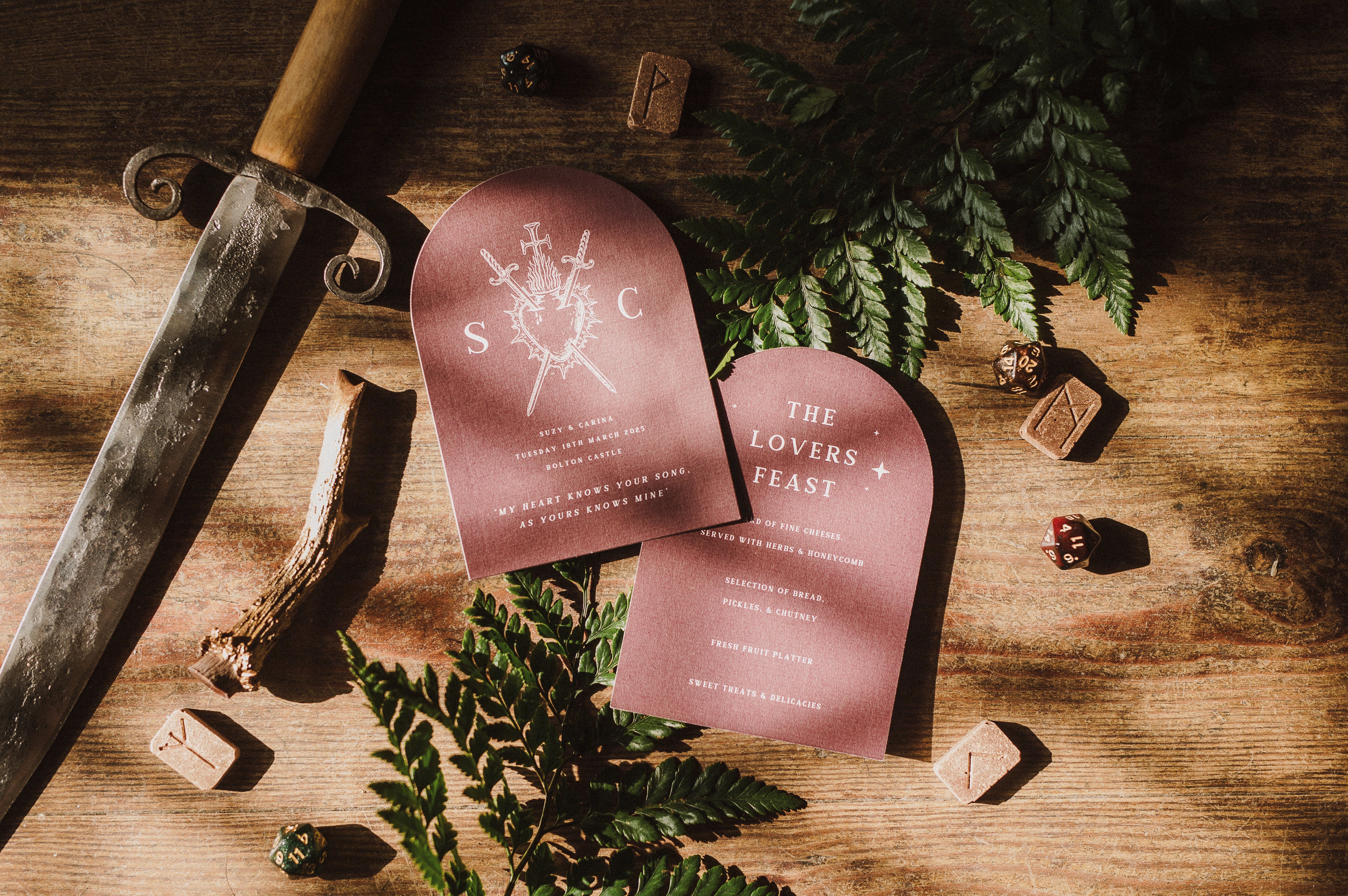 Luxury personalised wedding menu with mauve arched cards, white text, sword and fern motifs; romantic, gothic UK wedding stationery.