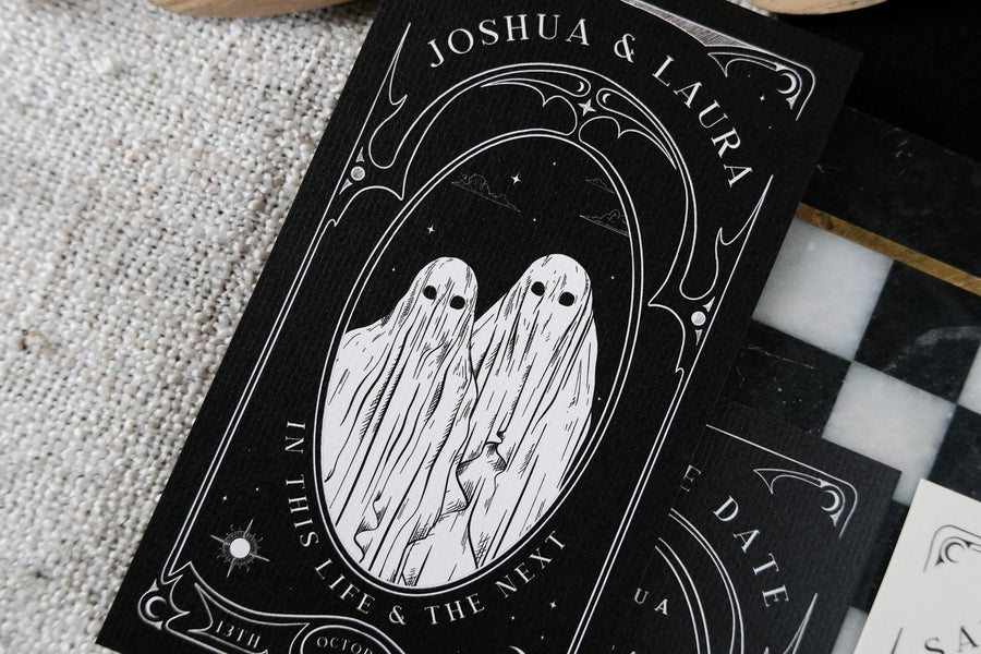 Luxury gothic wedding save the date card with vintage-inspired ornate borders, featuring two sheet-draped ghosts; alternative UK stationery.