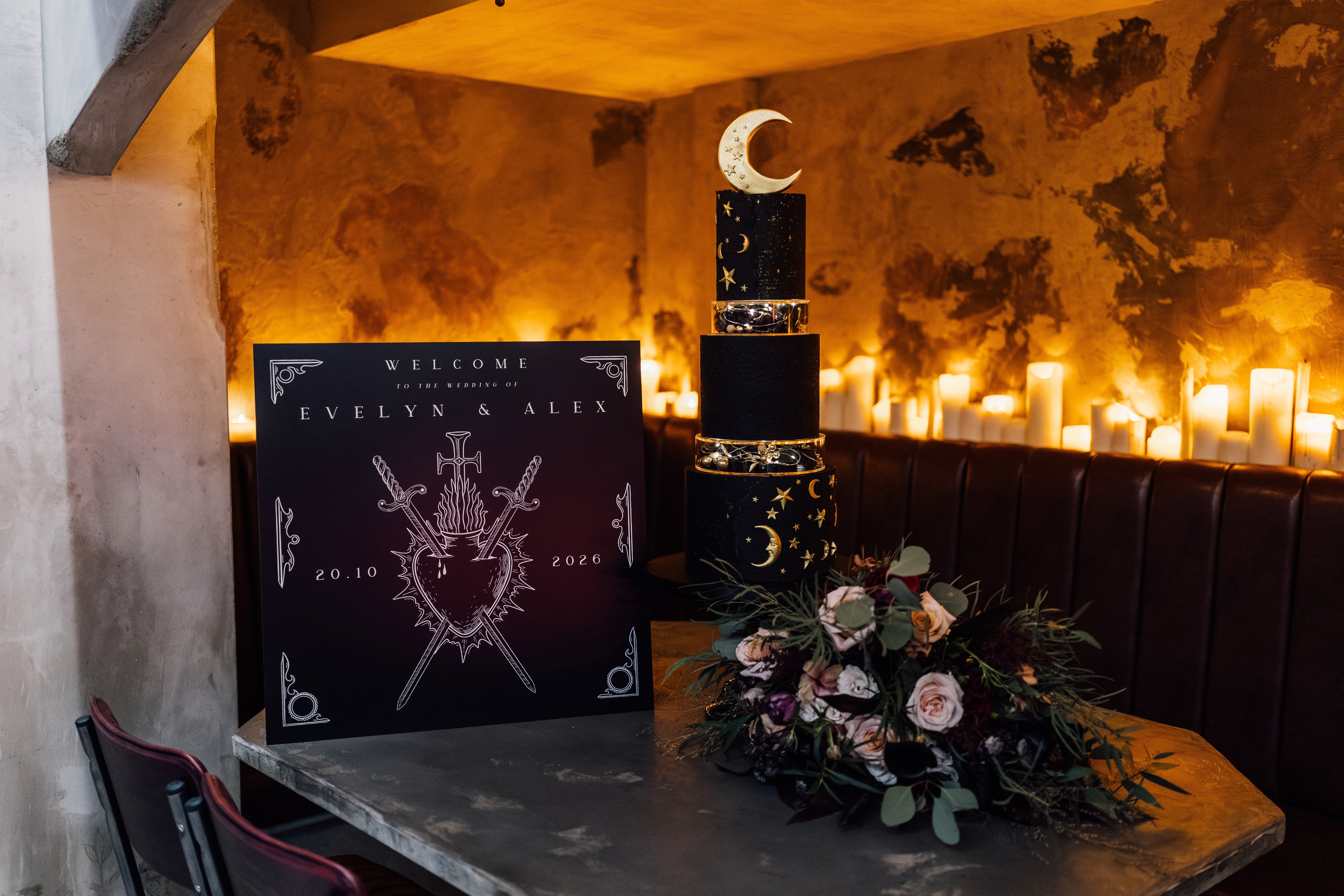 A luxury UK wedding display with celestial, gothic wedding stationery, gold foil accents, and glowing candles for a dramatic setting.